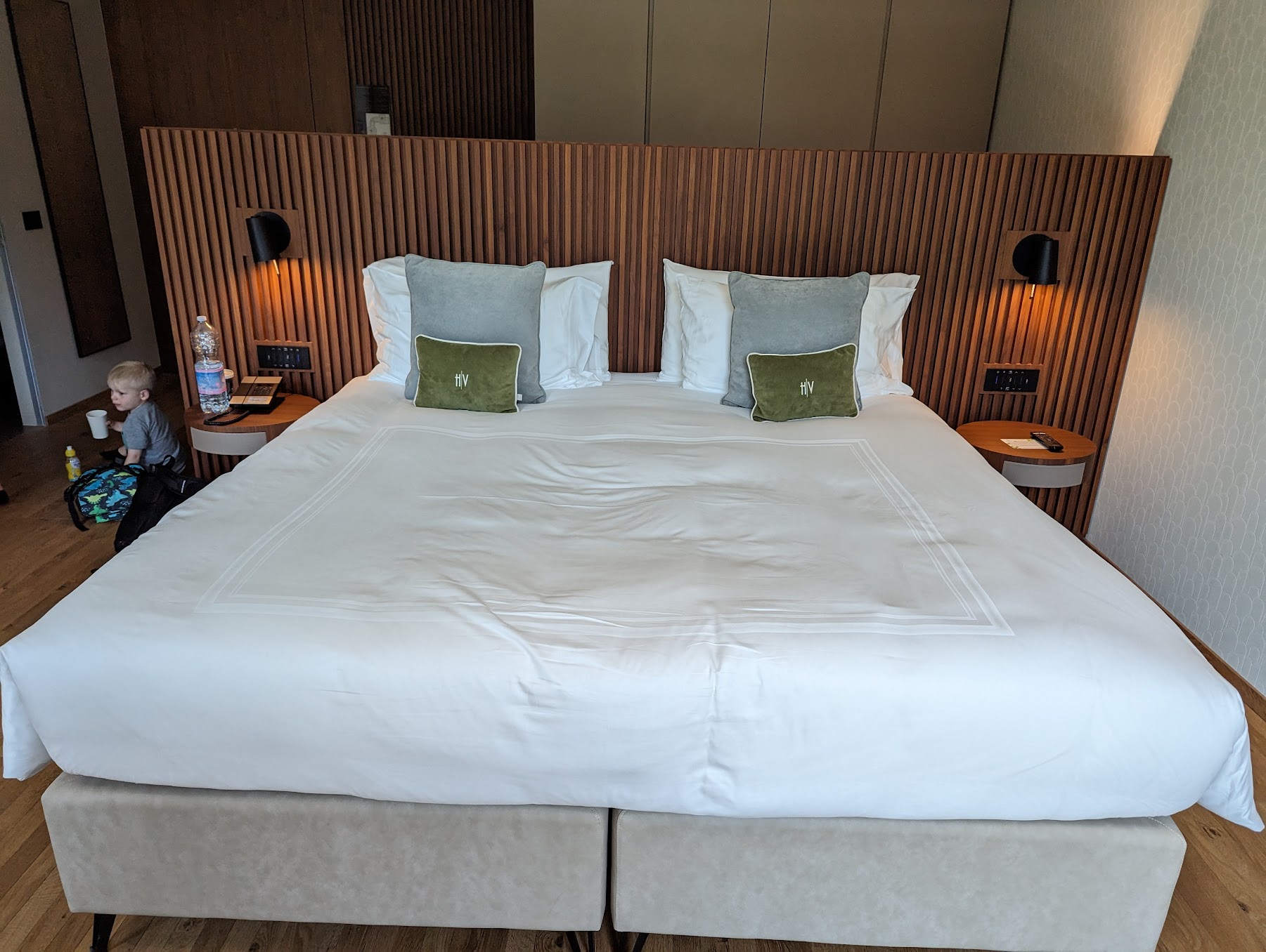 a bed with white sheets and pillows