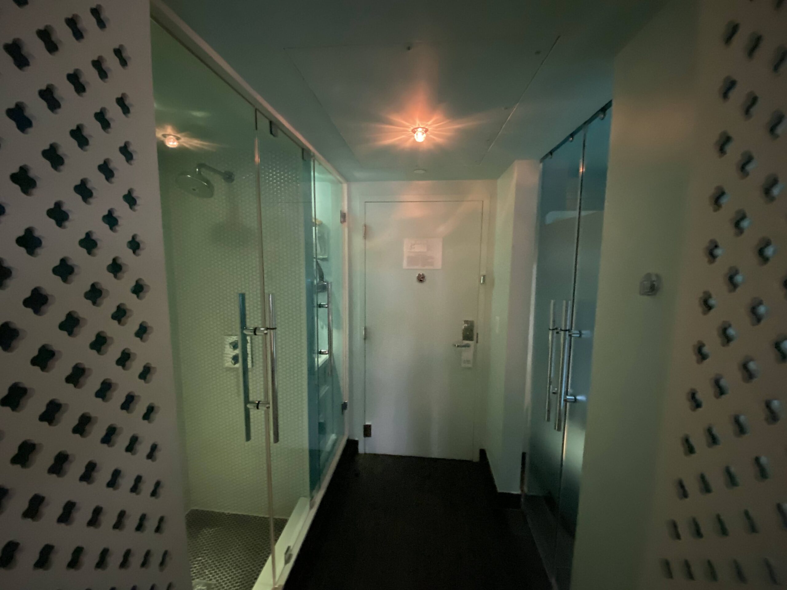 a bathroom with glass doors and a shower