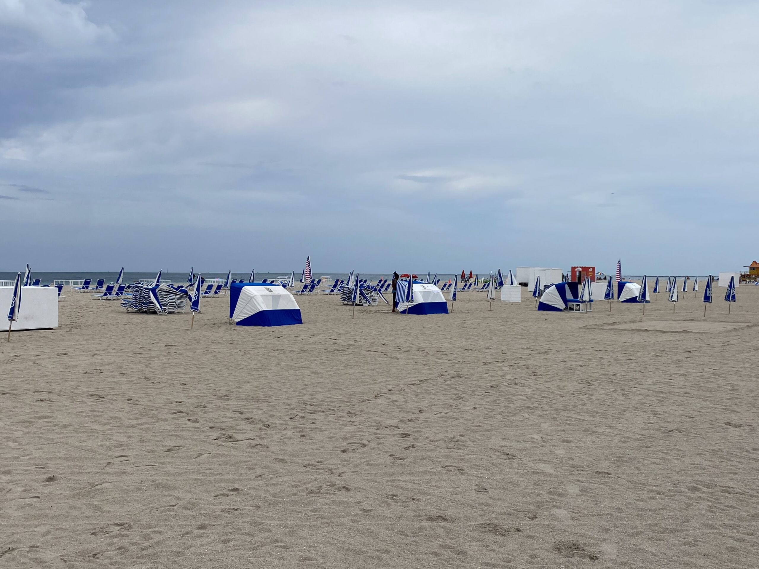 a beach with many tents and umbrellas