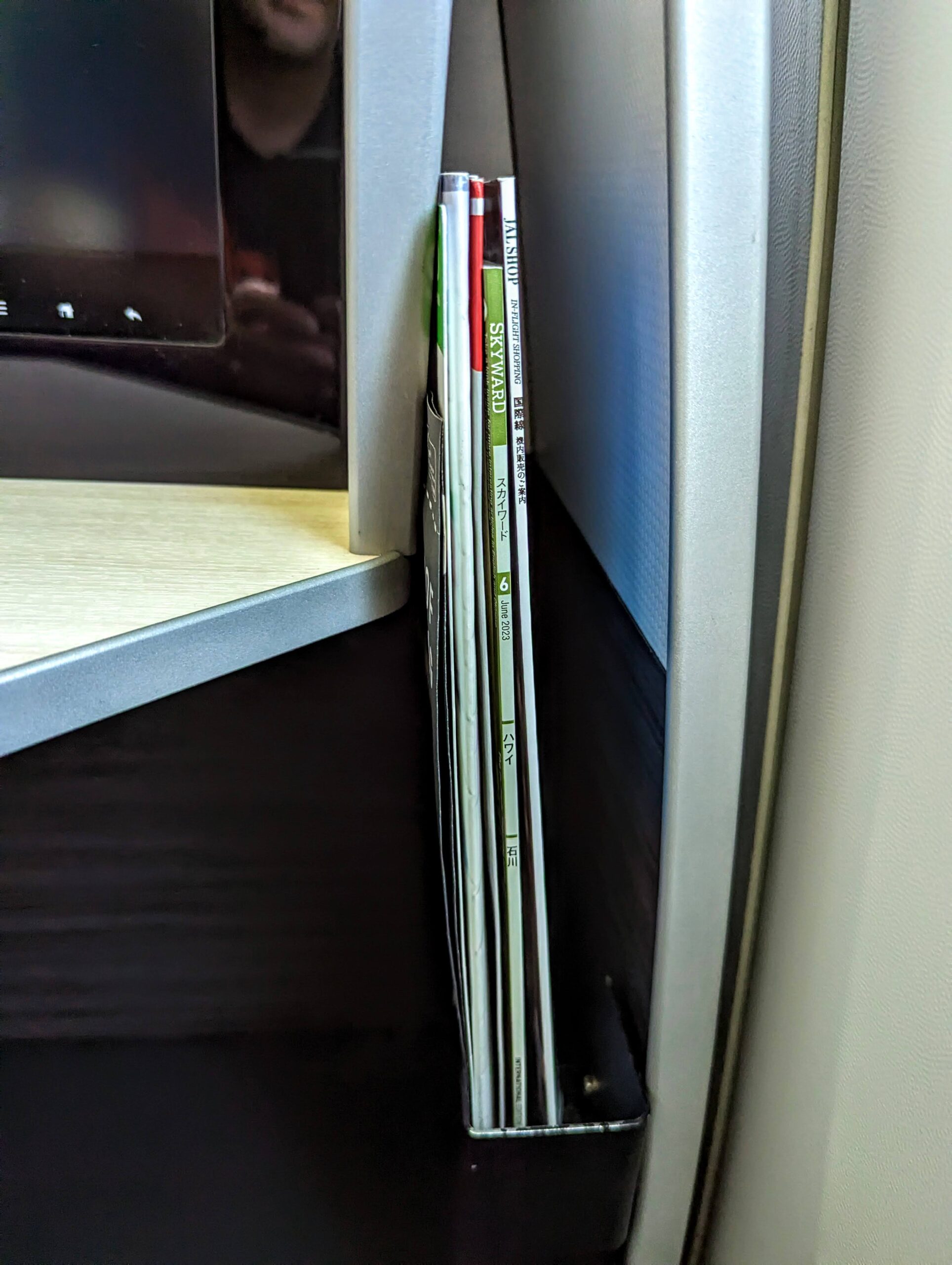 a stack of magazines on a shelf