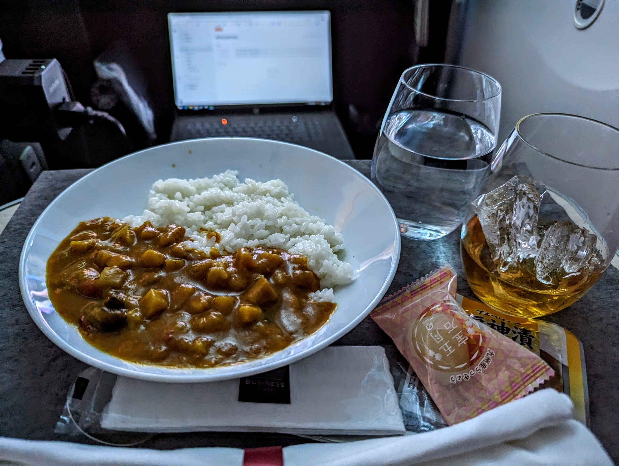 a plate of food and glasses of water on a table