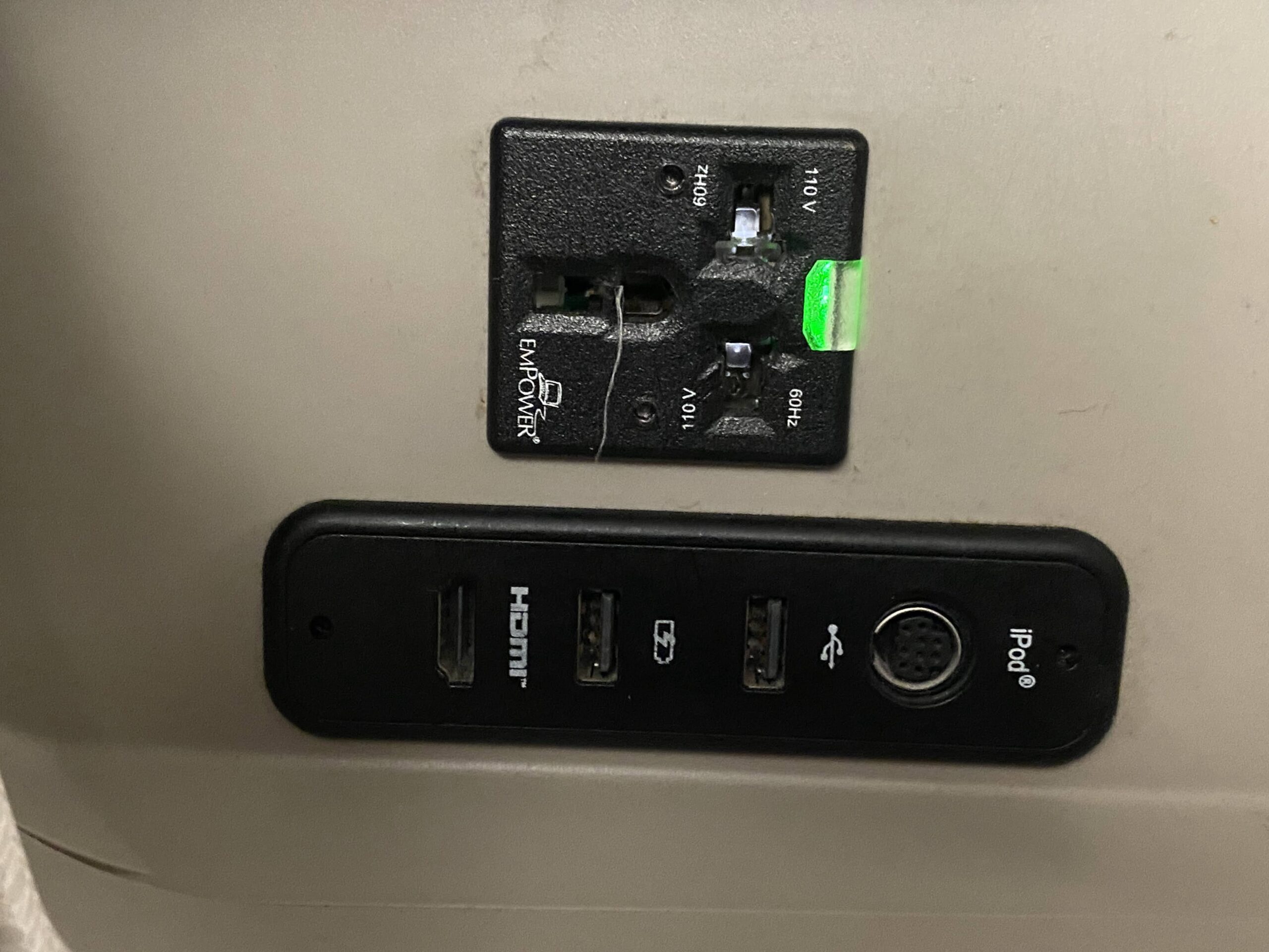 a black outlet with a black plug and a black plug on a white surface