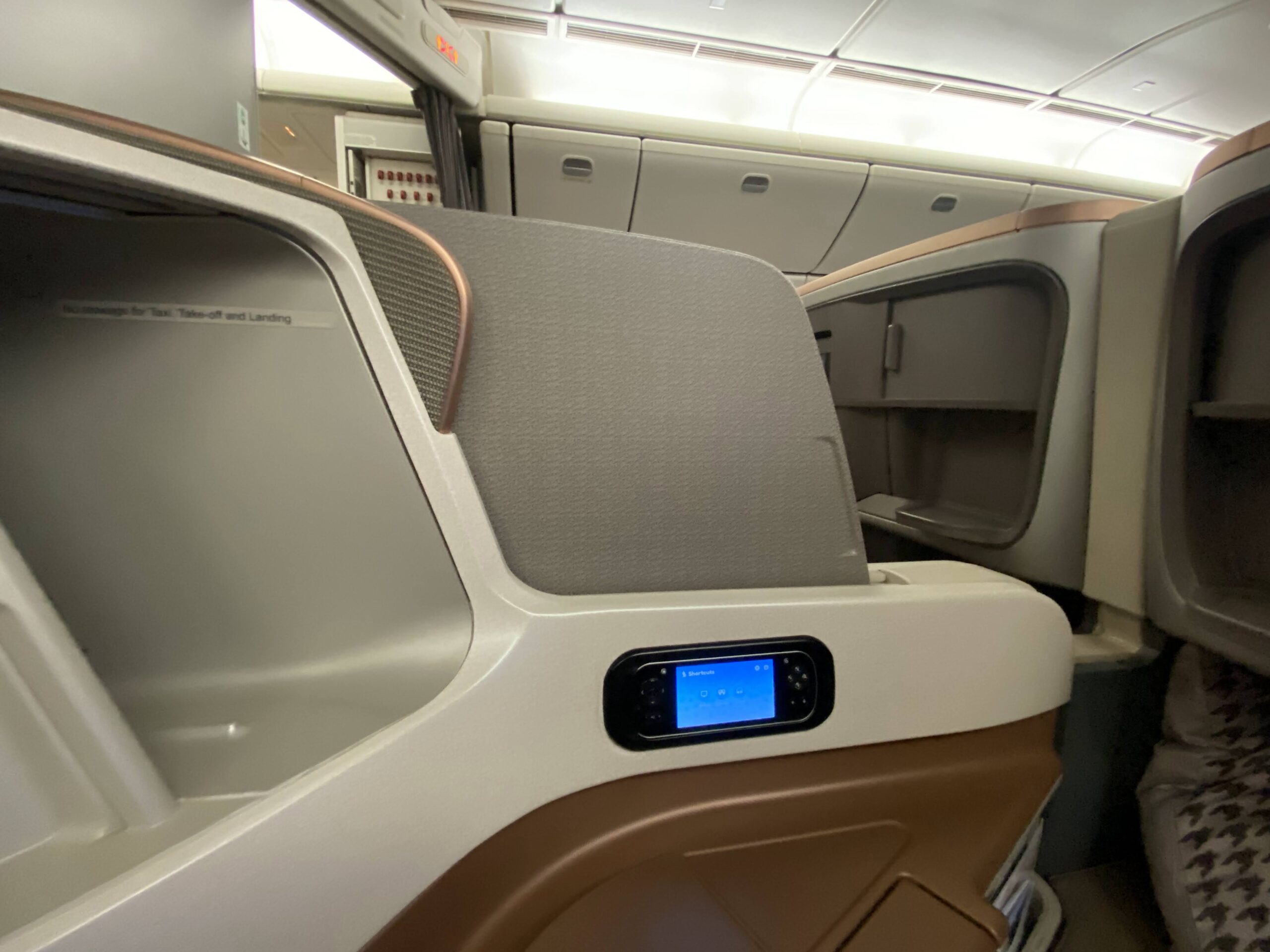 an airplane seat with a screen