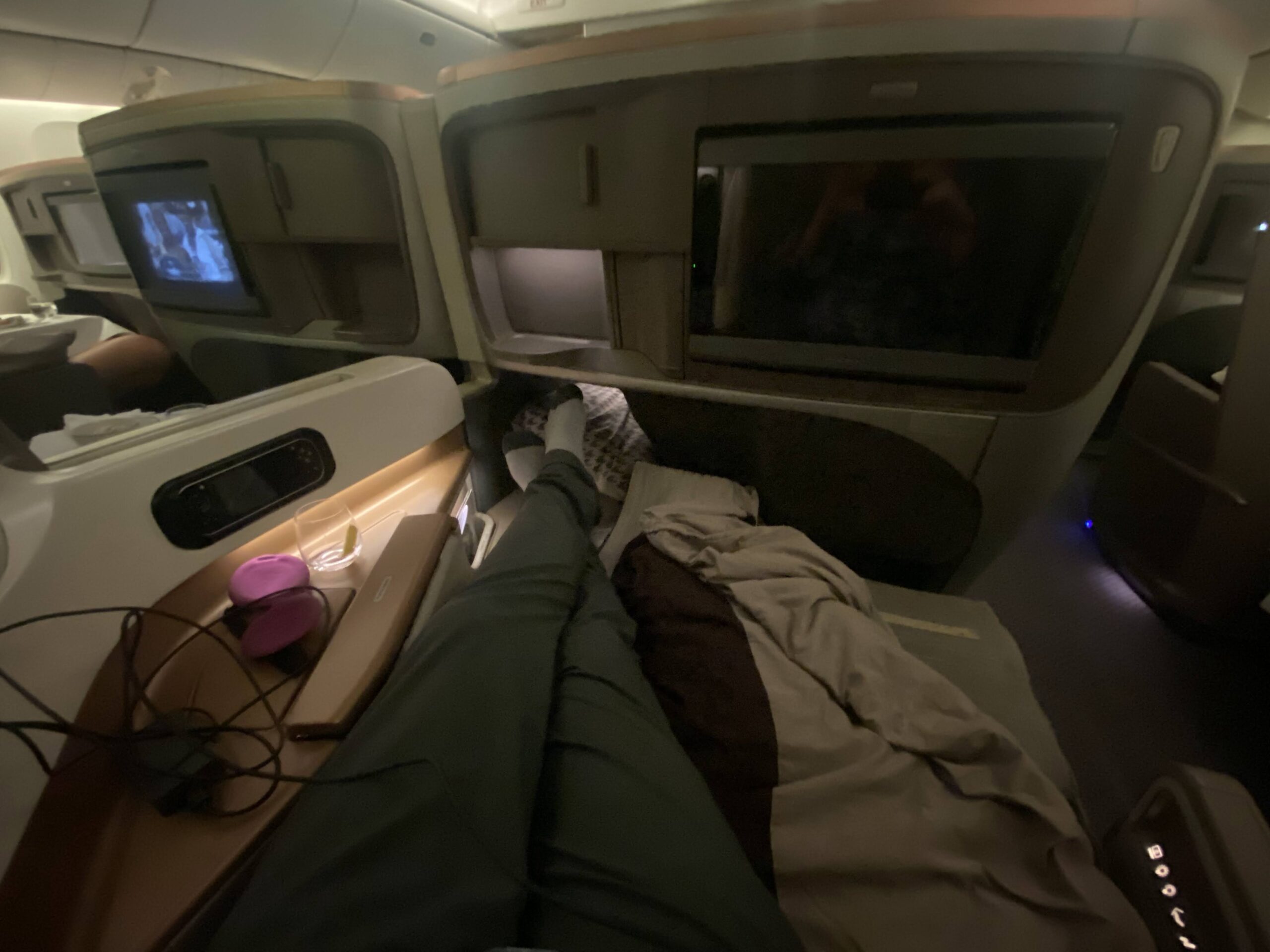 a person's legs on a bed in an airplane