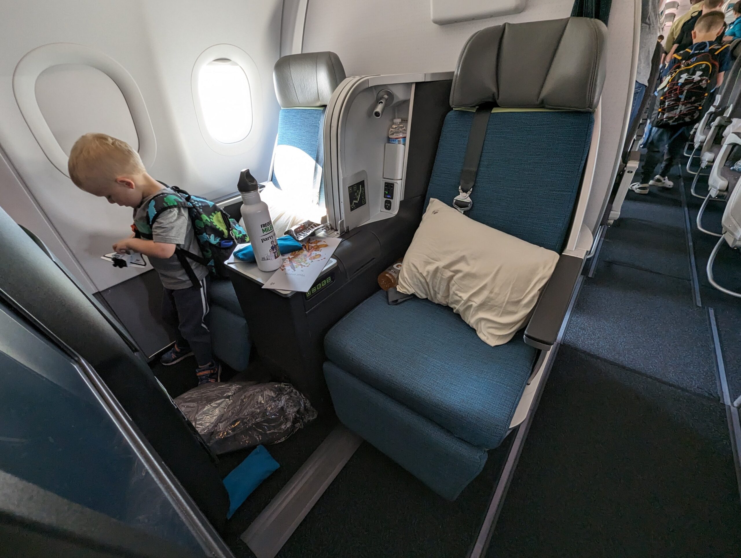 a child standing in a chair in an airplane