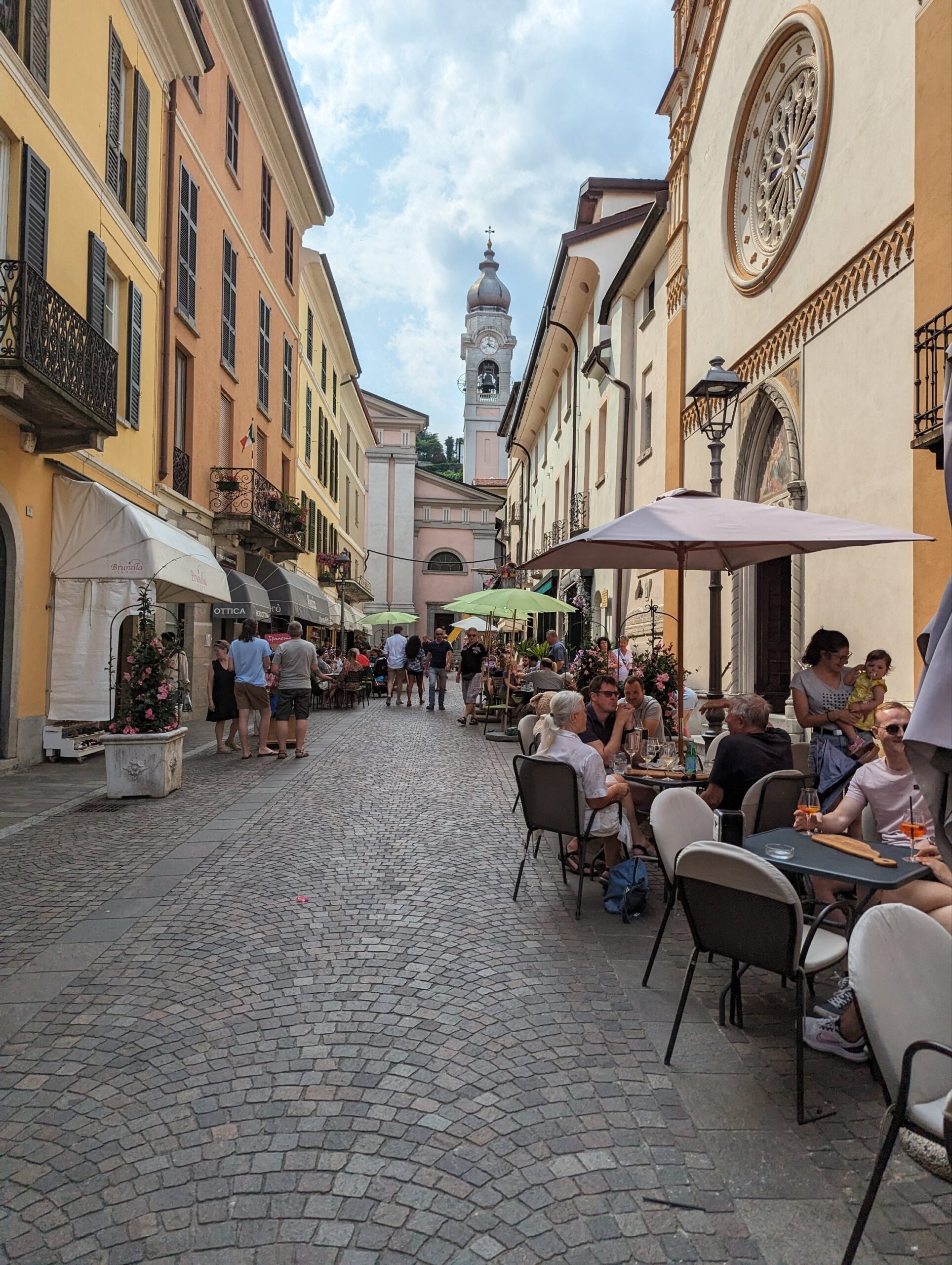 a group of people sitting at tables outside a building