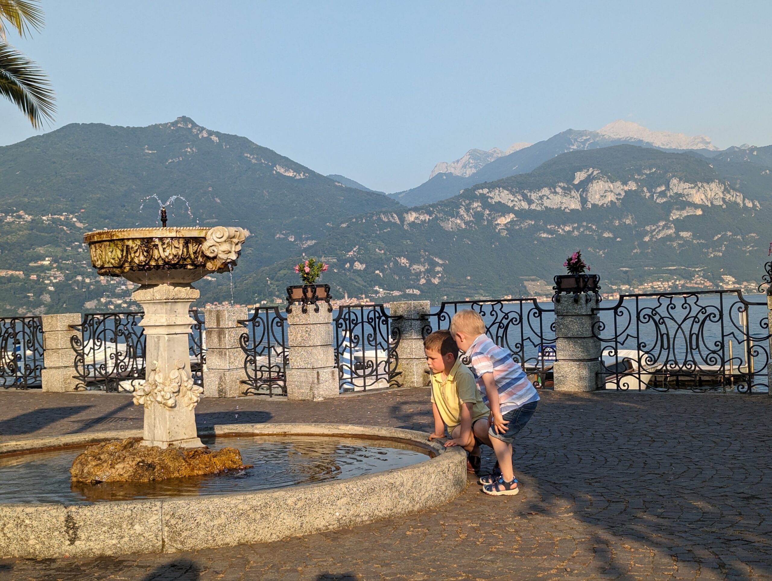 two children playing in a fountain