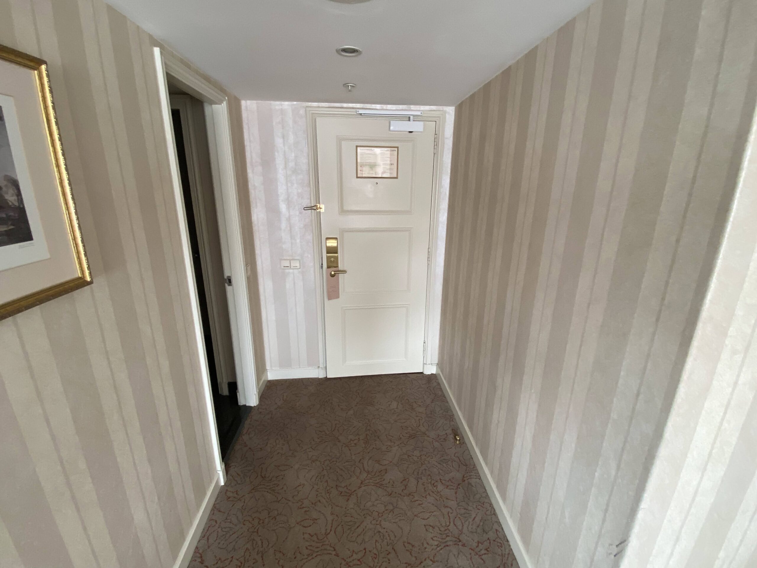 a hallway with striped walls and a door