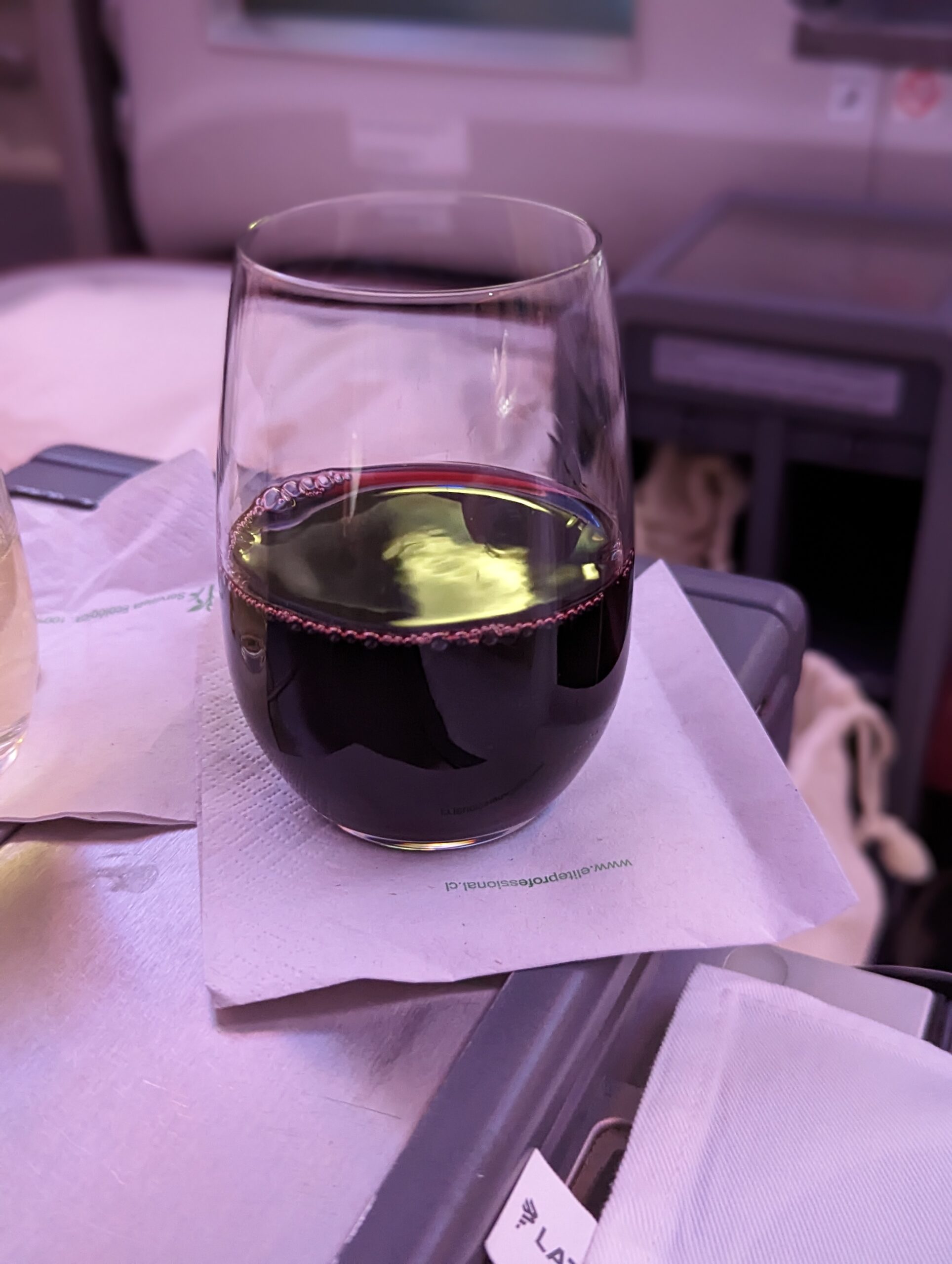 a glass of wine on a napkin