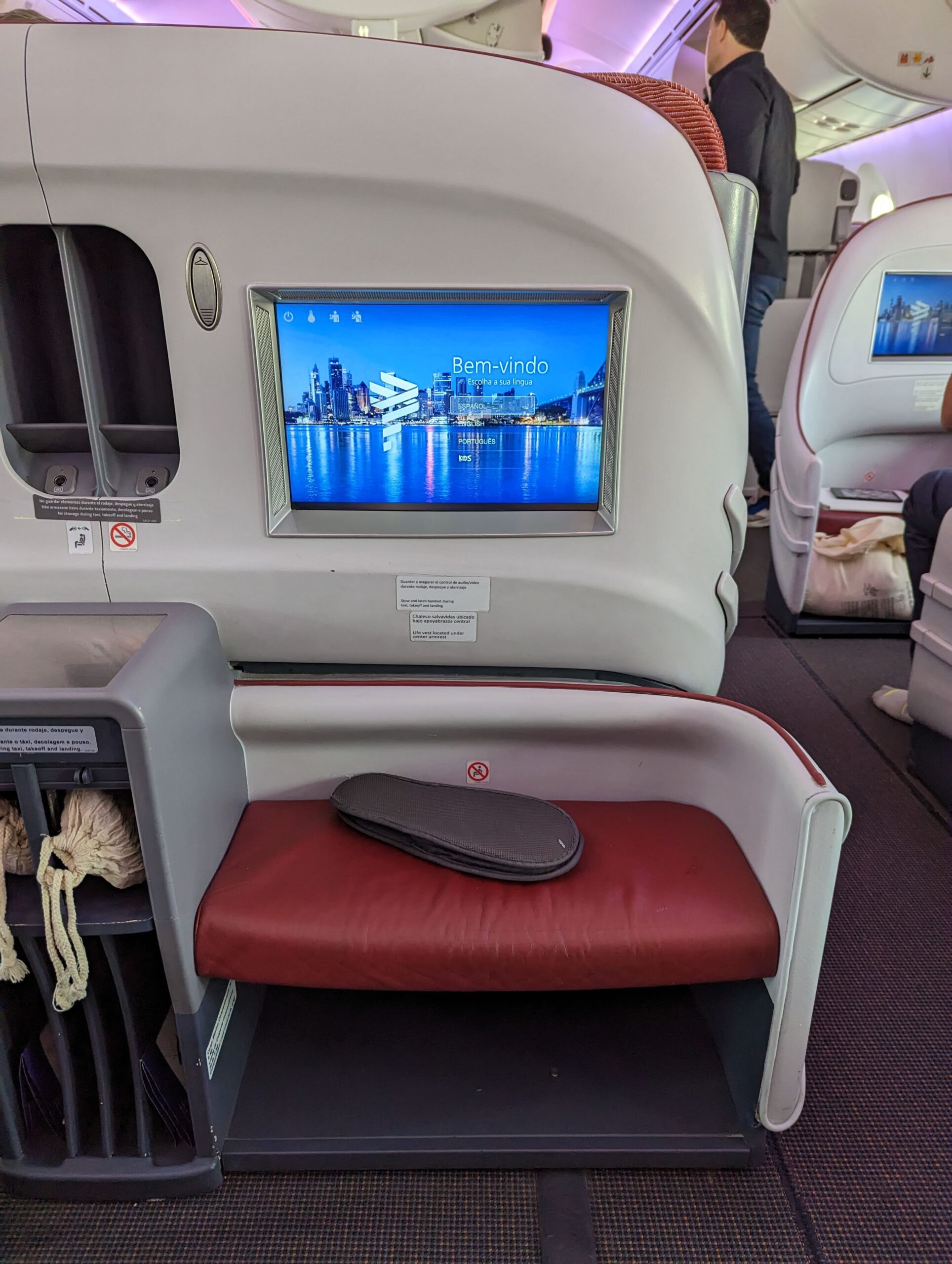 a tv screen on a seat in an airplane