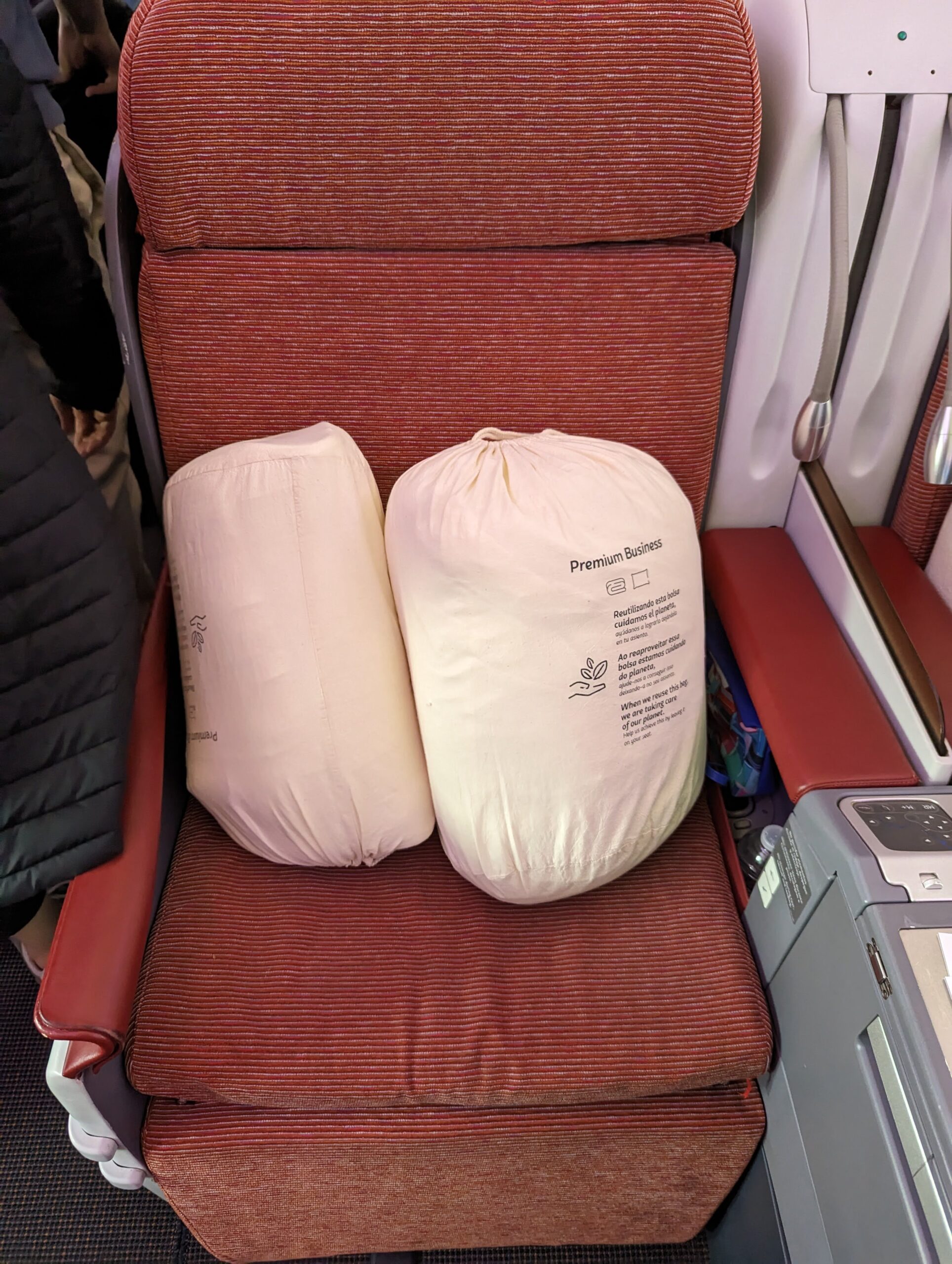 two white bags on a red seat