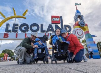 a group of people posing for a picture with a sign