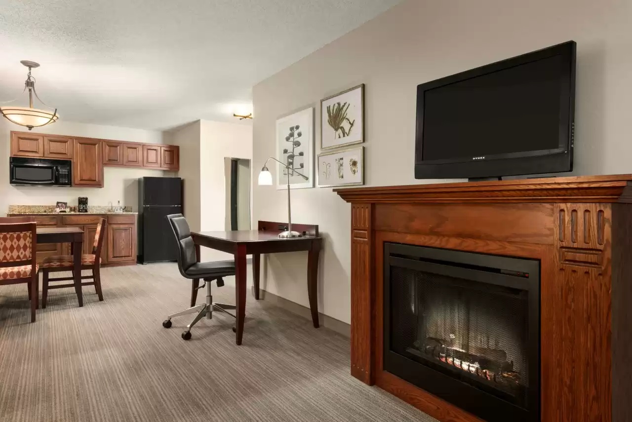 Living room & kitchen of the 1 King Bed, Suite, Kitchenette at the Country Inn & Suites By Radisson, Kansas City At Village West, KS (image courtesy of Choice Hotels)