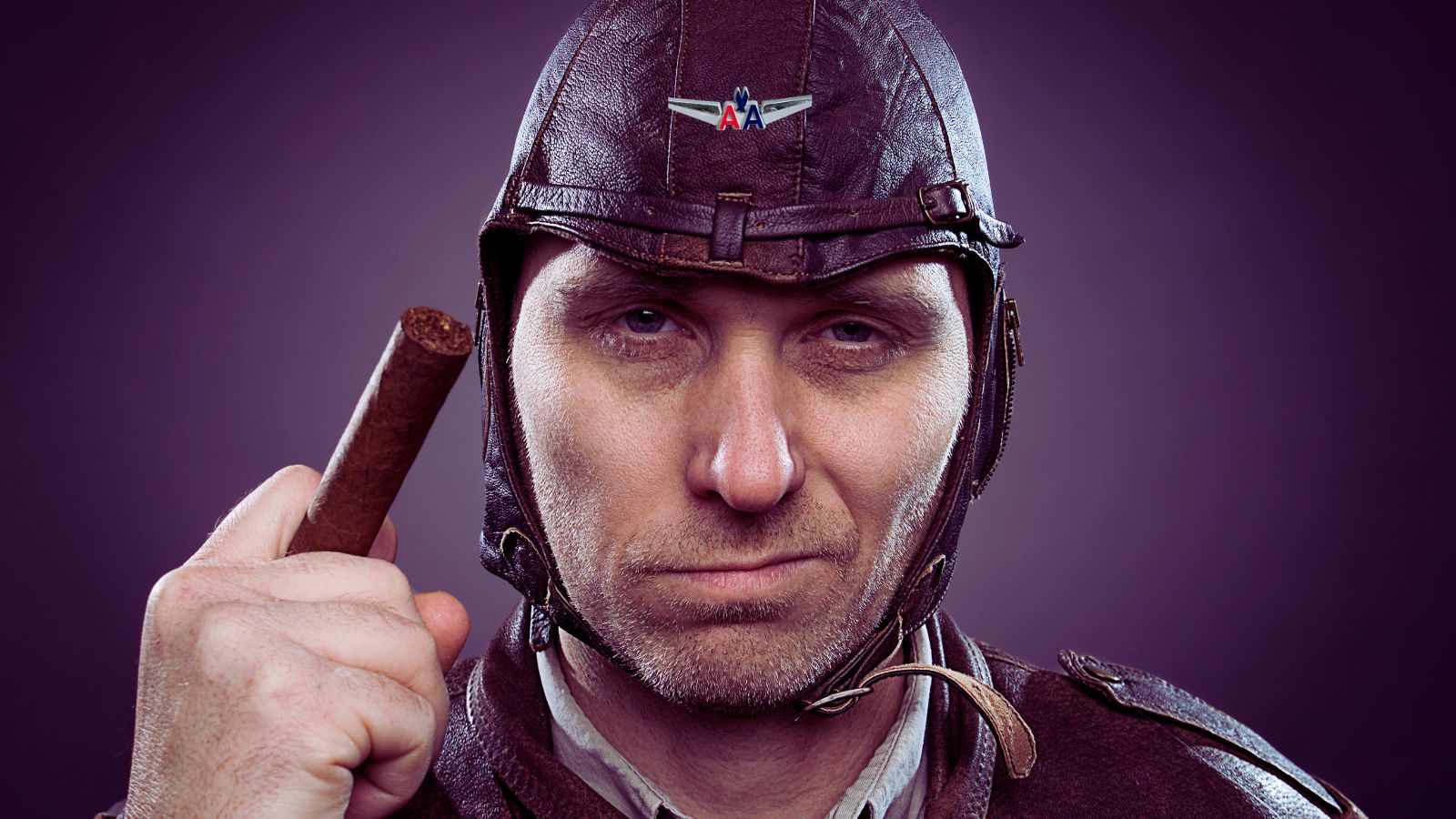 a man in a helmet holding a cigar