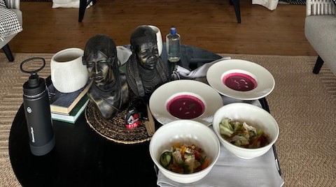 a table with bowls of food and statues