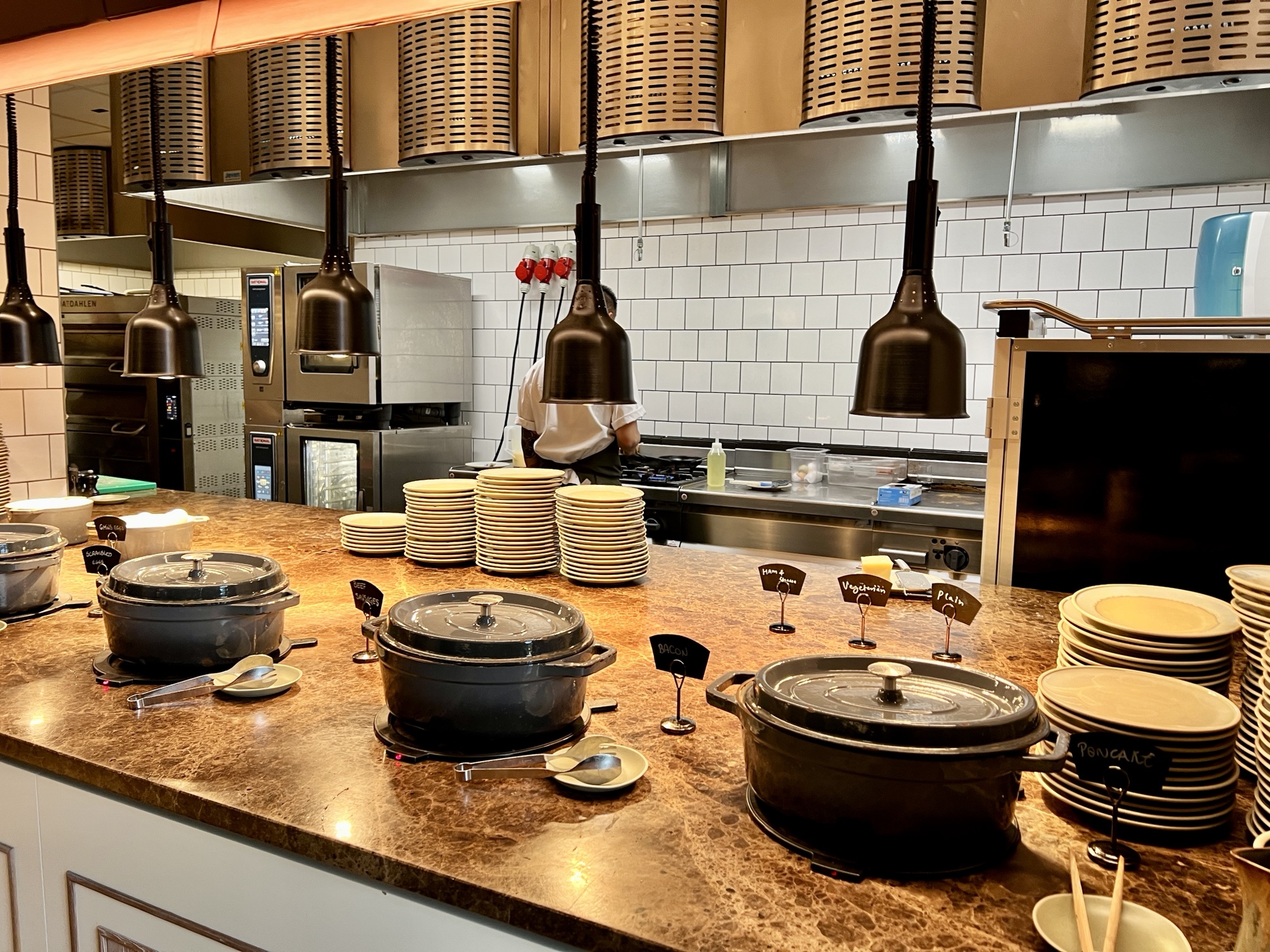 a kitchen with many pots and plates
