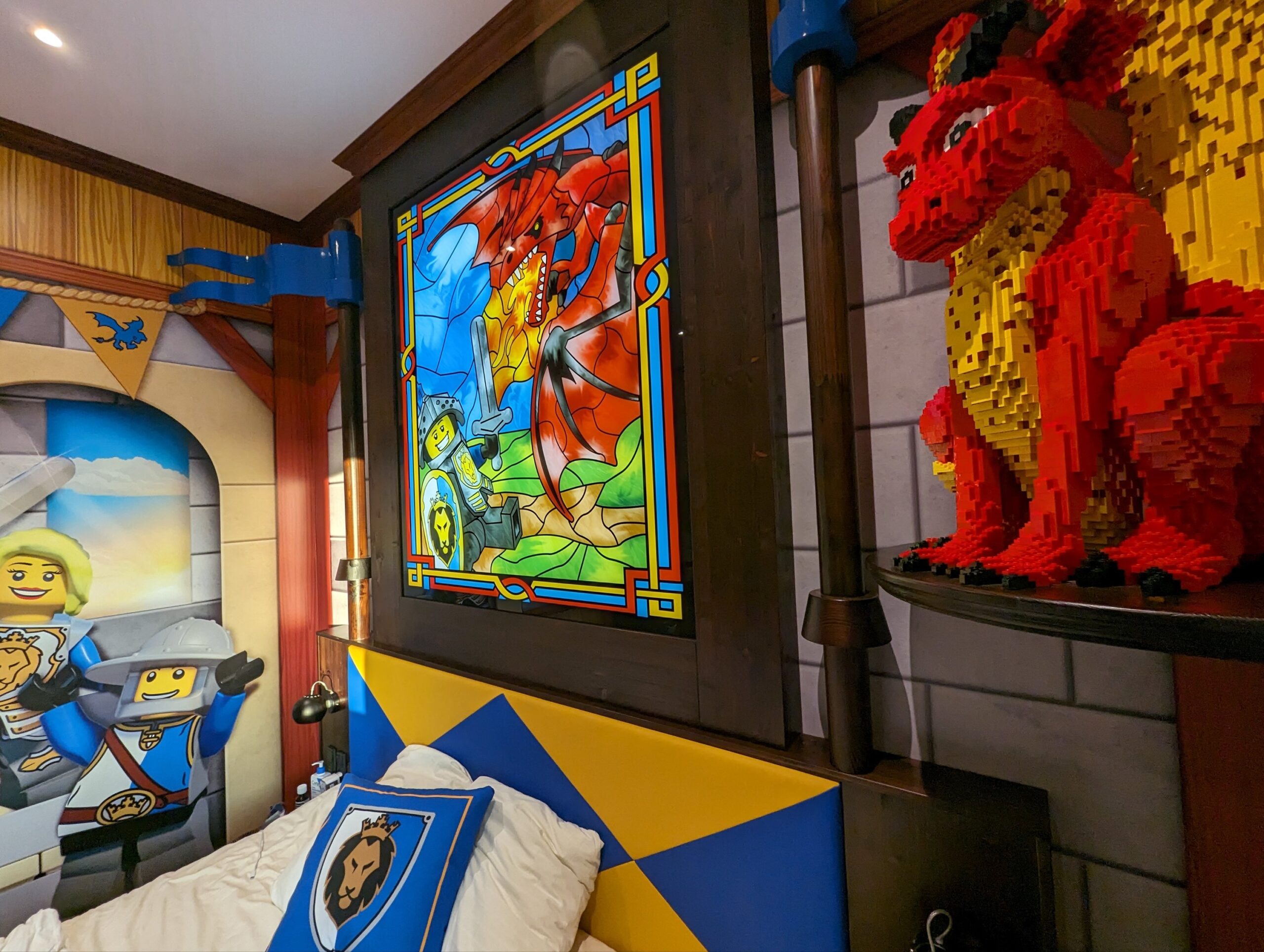 a bed with a picture of a dragon and a statue of a dragon