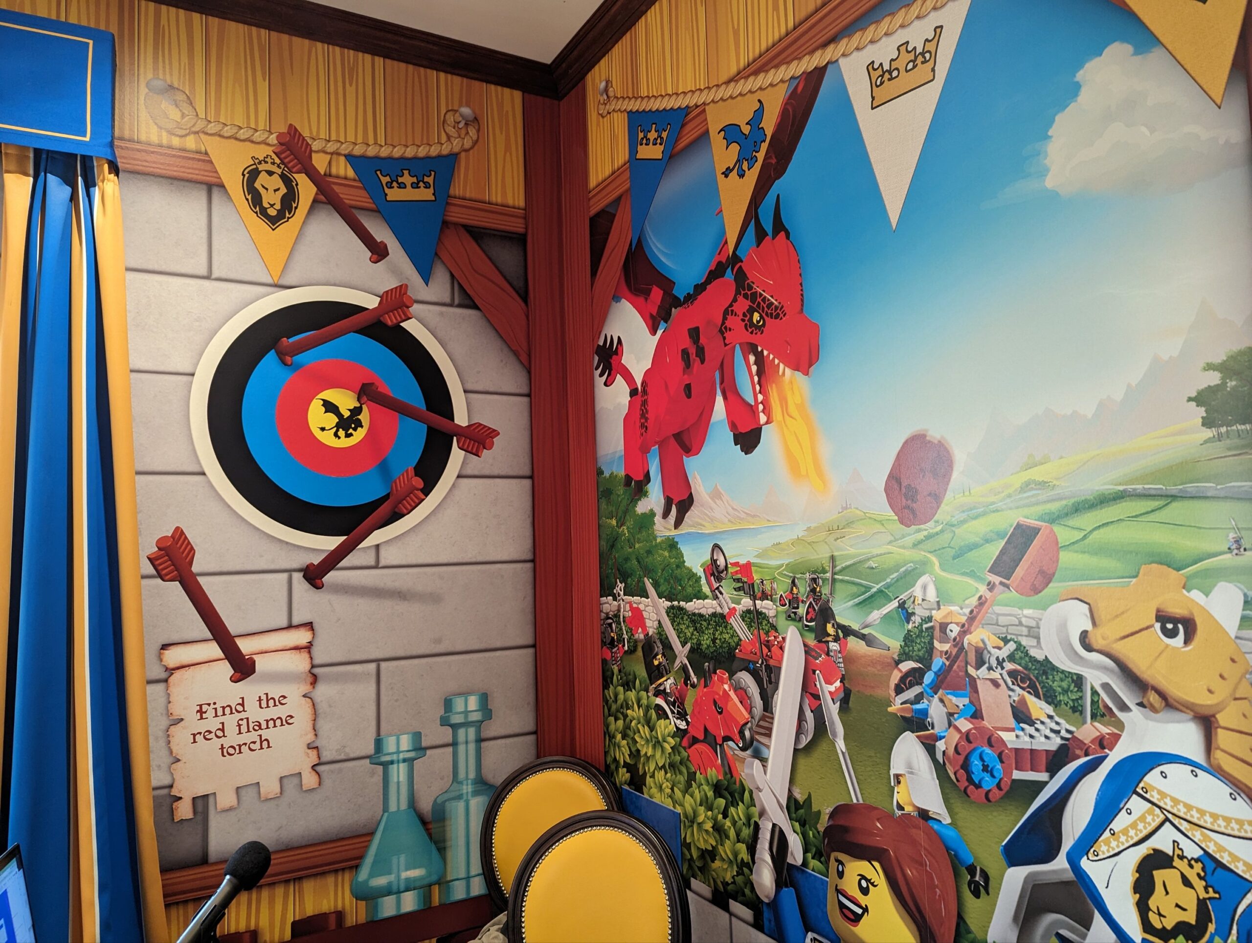 a room with a mural of a castle and a wall with a cartoon wall