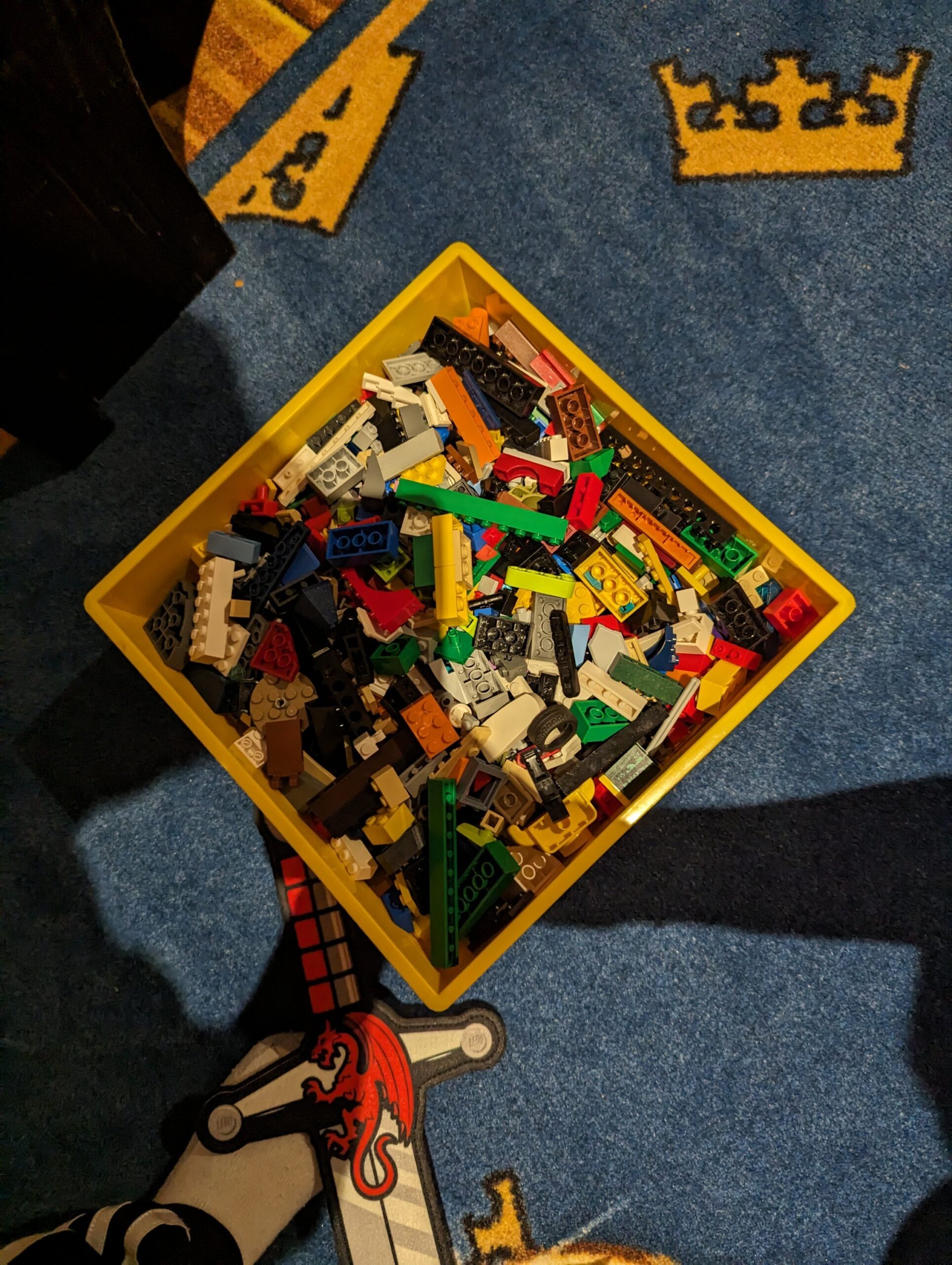 a yellow box with lego pieces in it
