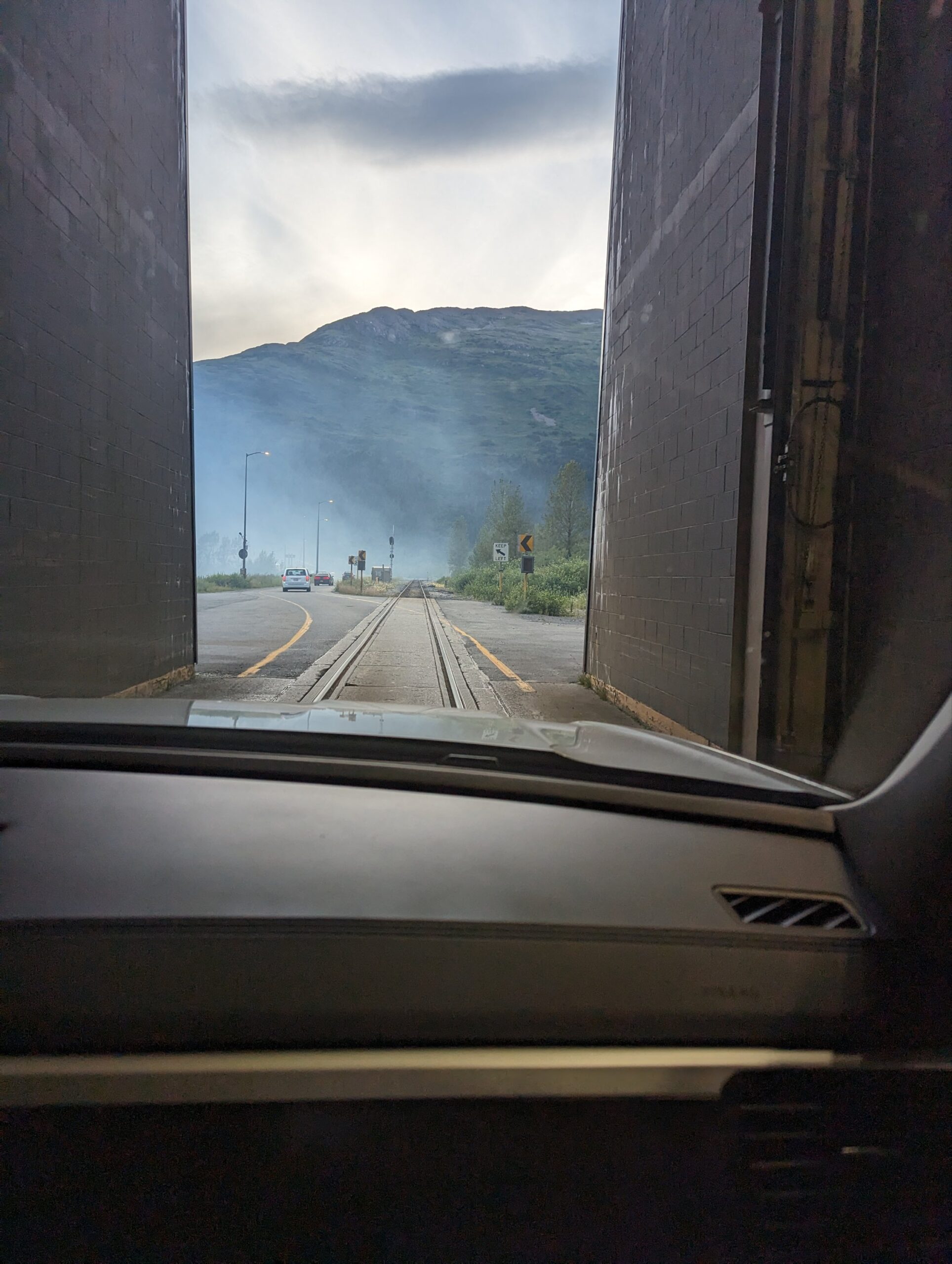 looking through a tunnel to a road