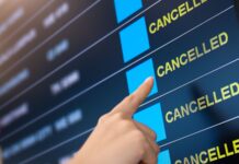 Takeaways from a trip cancelled at the last minute a hand pointing at a flight schedule