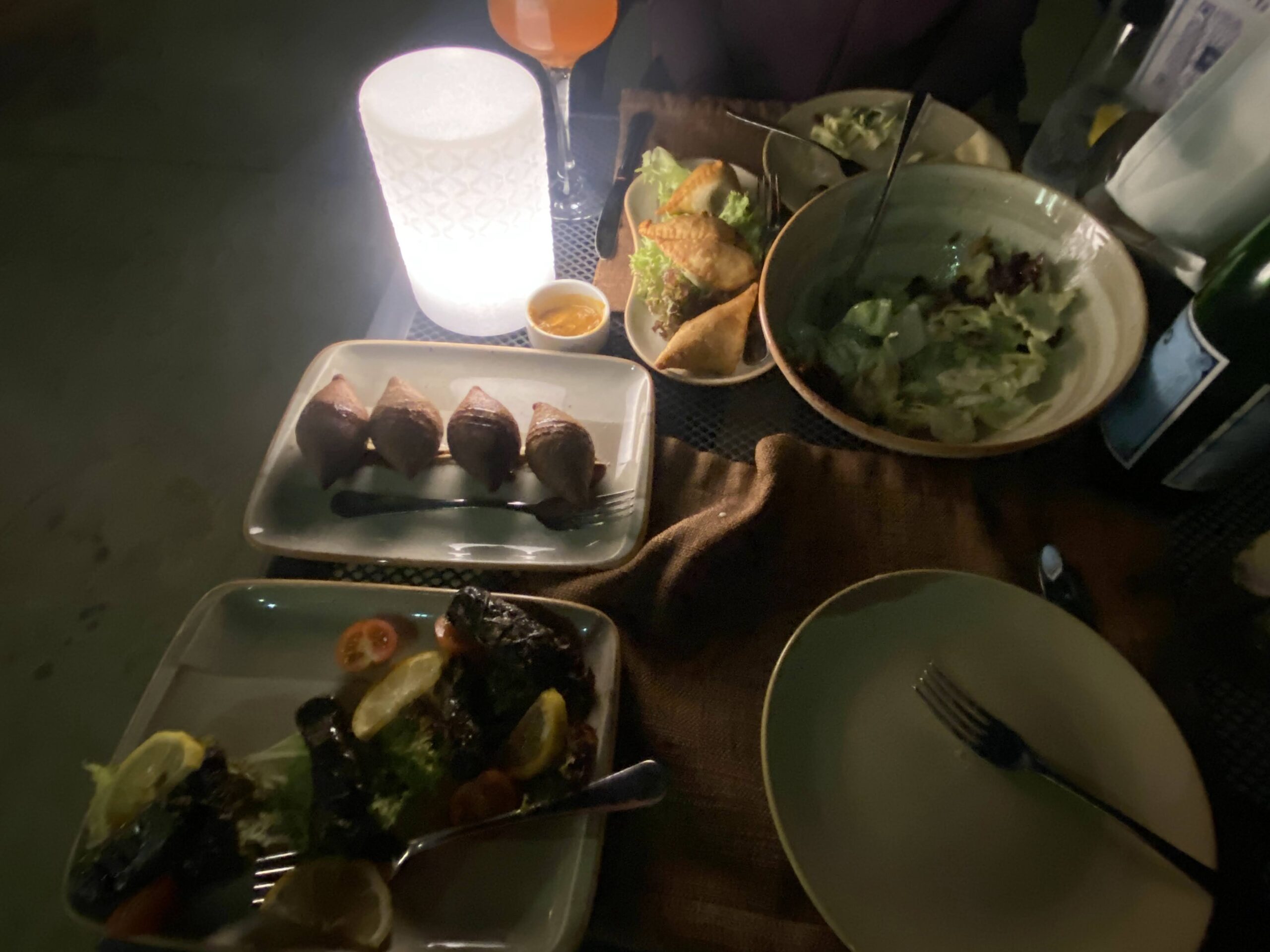a table with plates of food and a candle