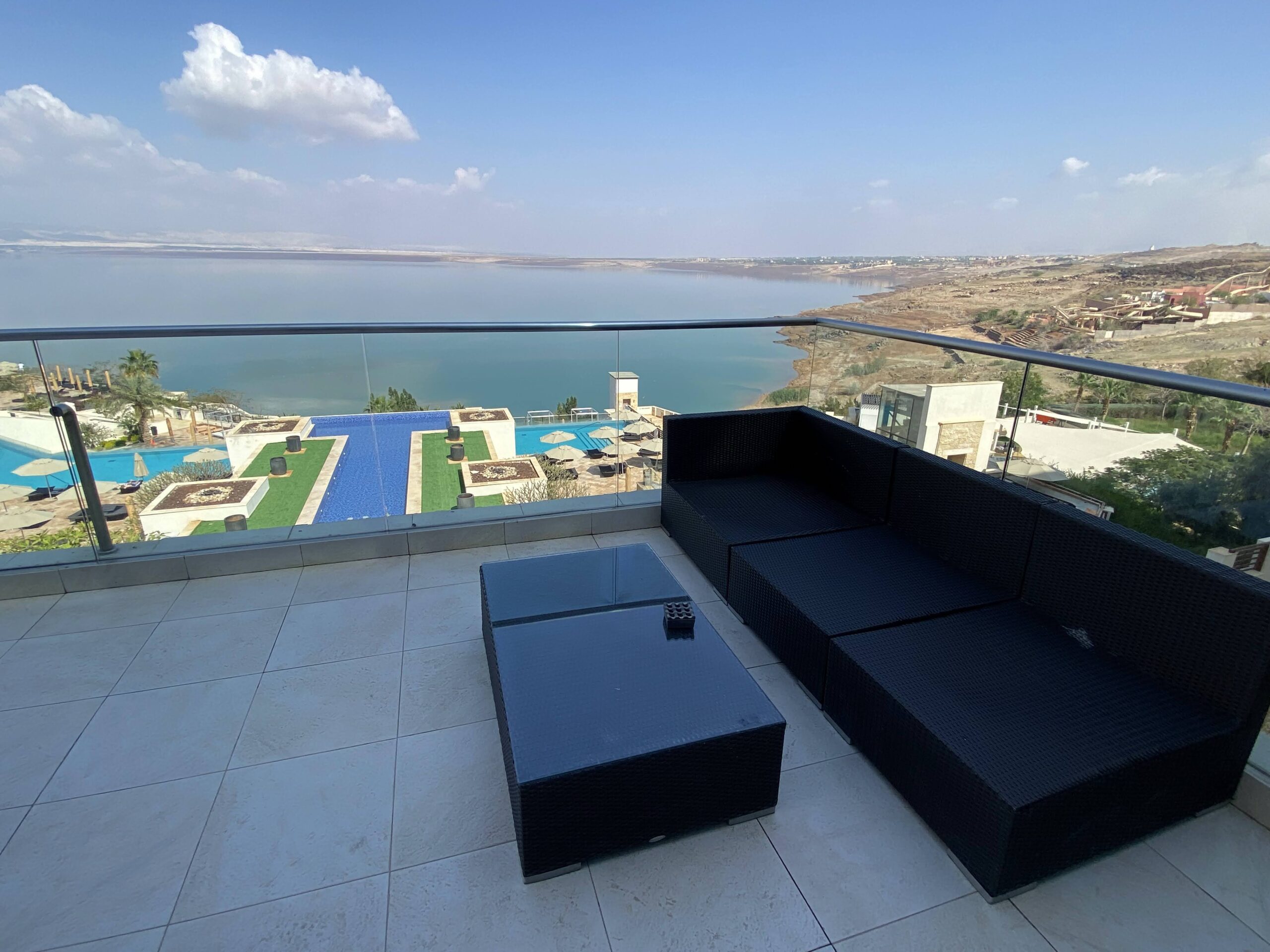 a couches on a balcony overlooking a body of water