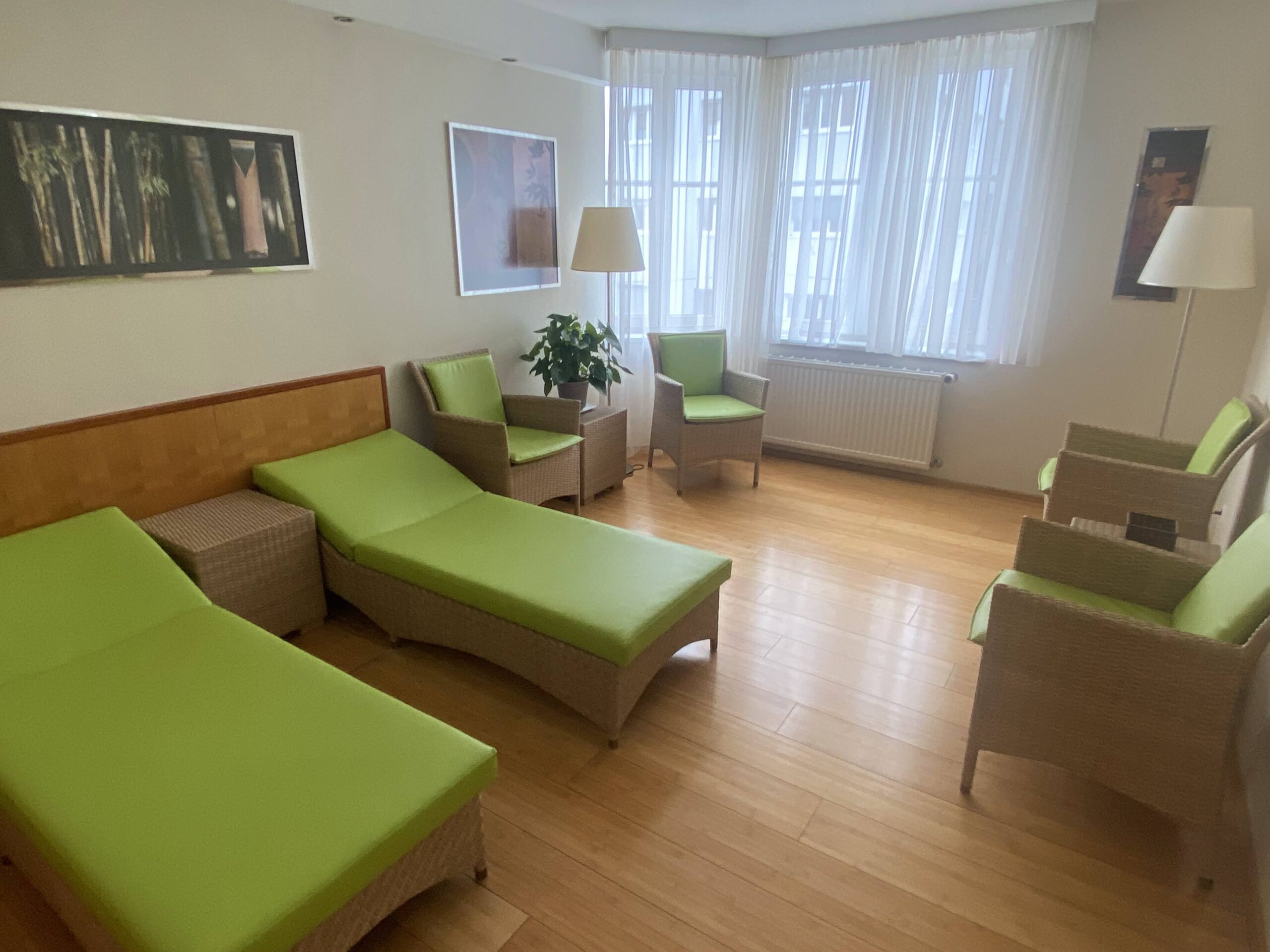 a room with green chairs and a lamp