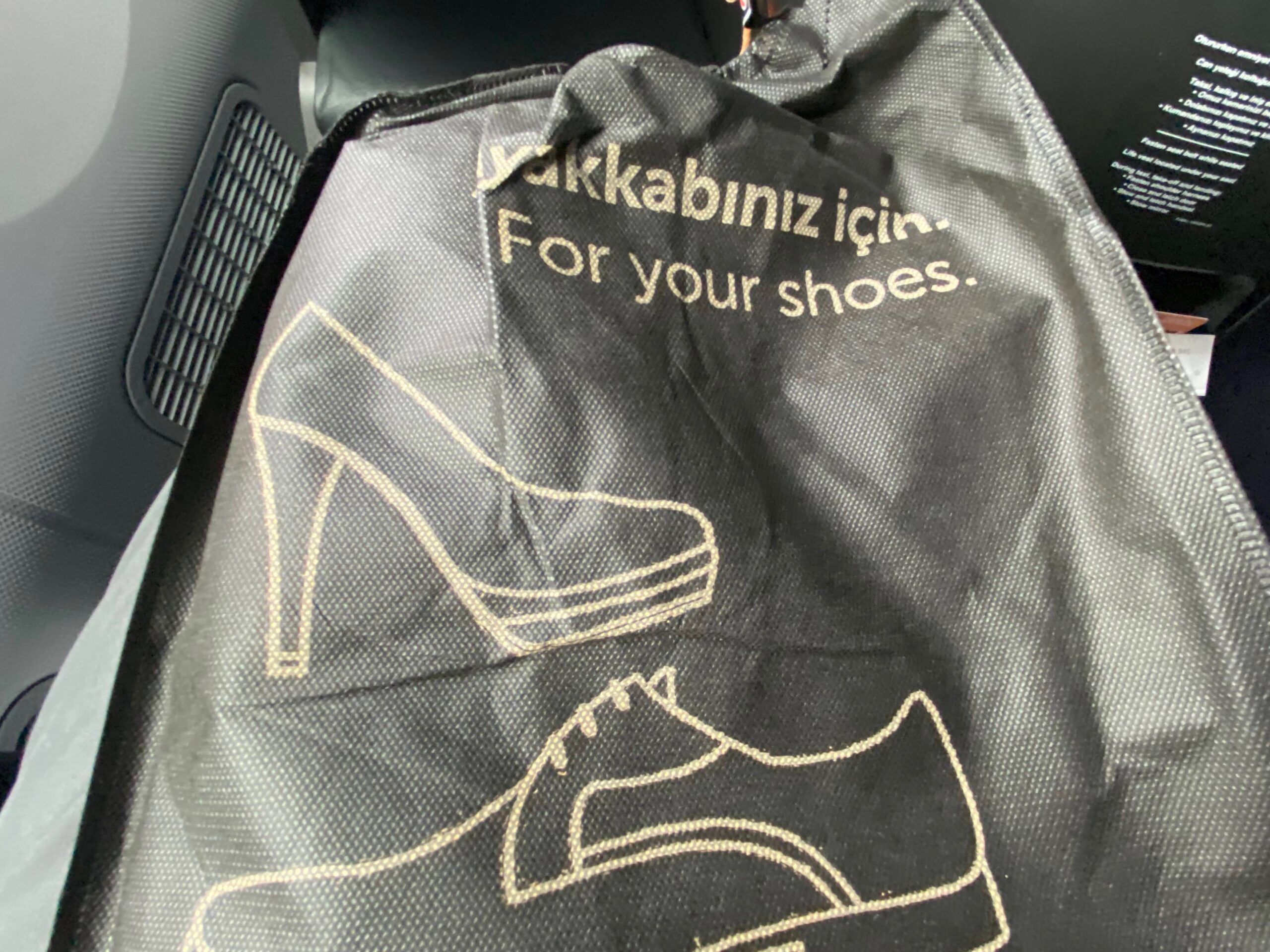 a black bag with a picture of shoes on it