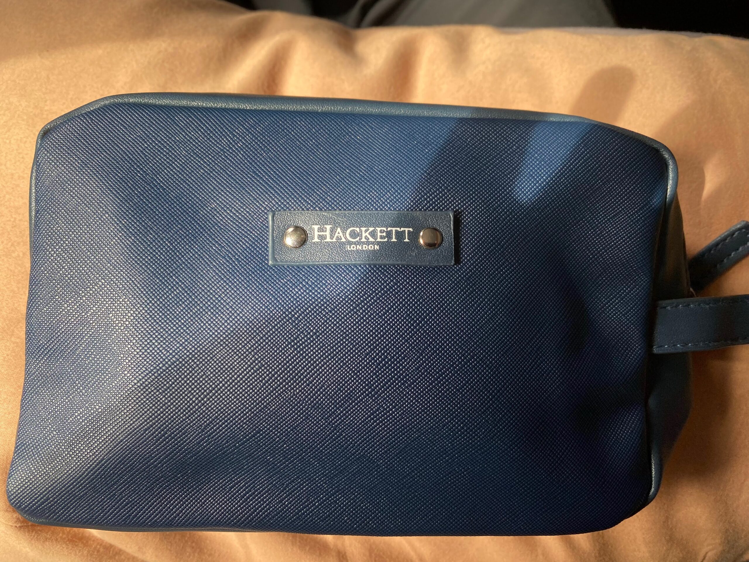 a blue leather case with a name tag