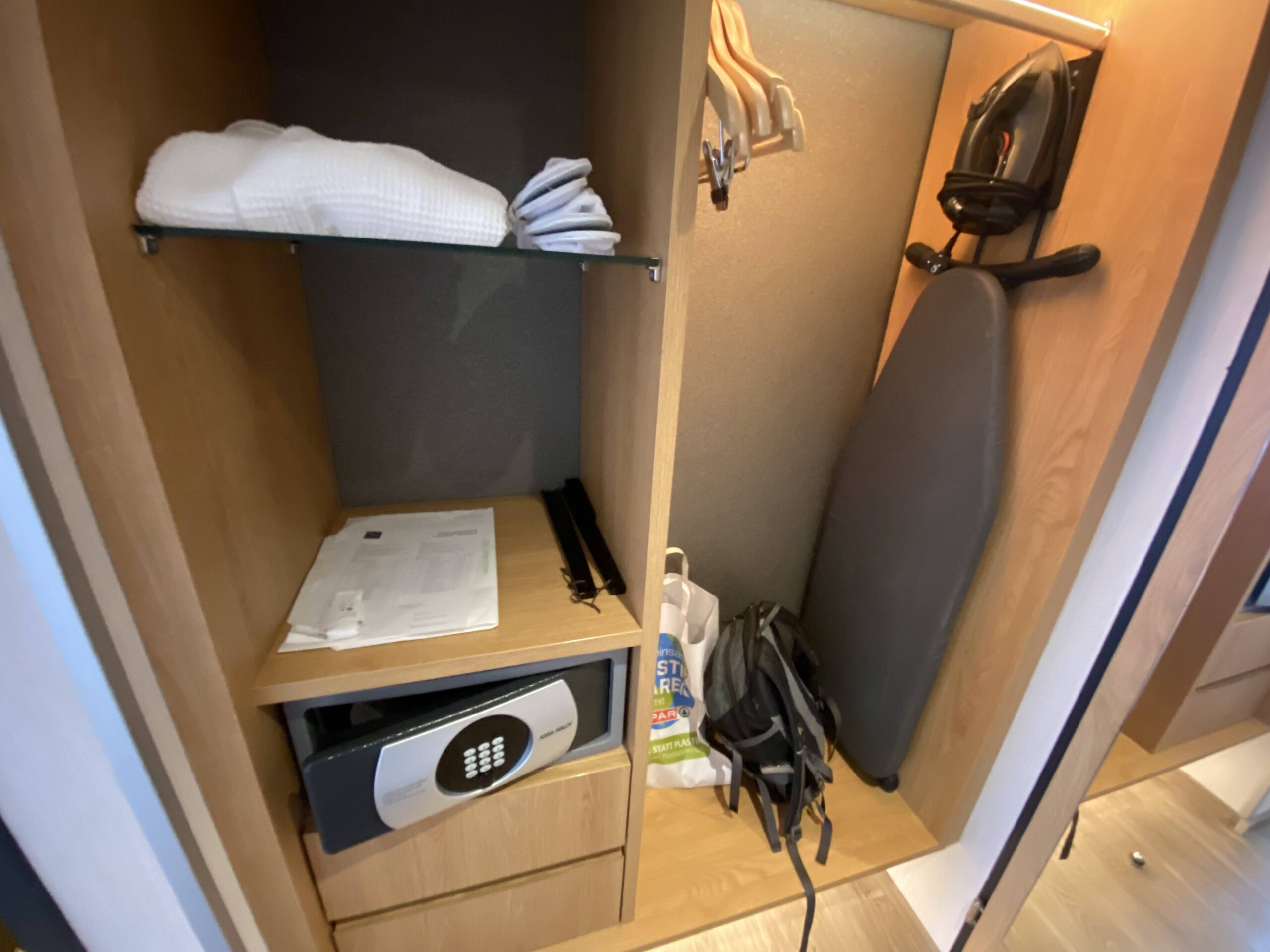 a closet with a ironing board and a small ironing board