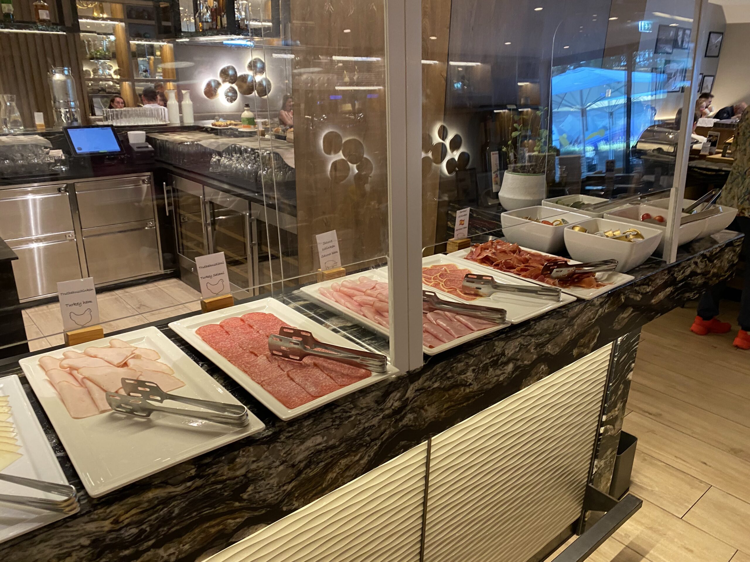 a buffet with meat and tongs