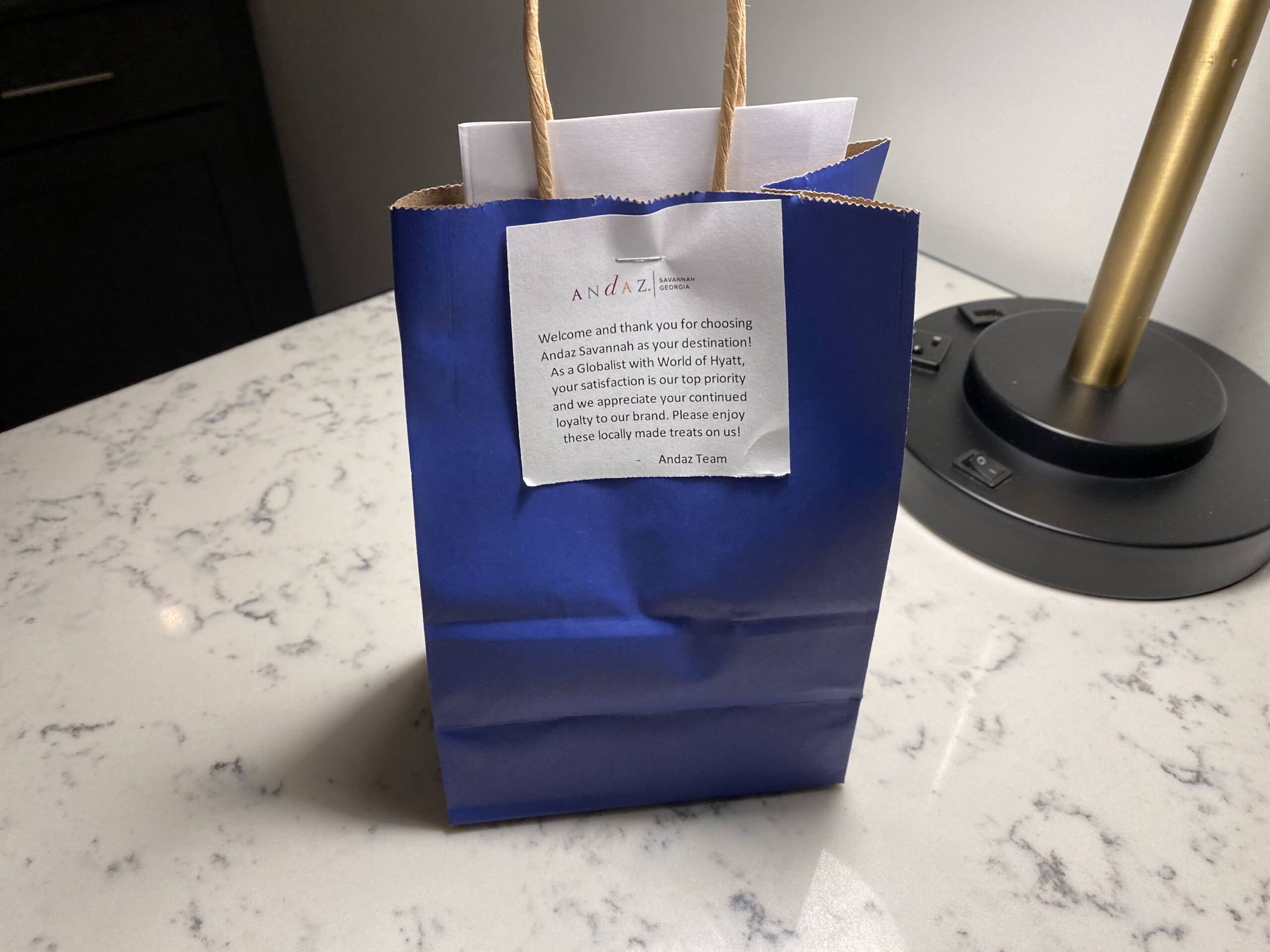 a blue bag with a white paper on it