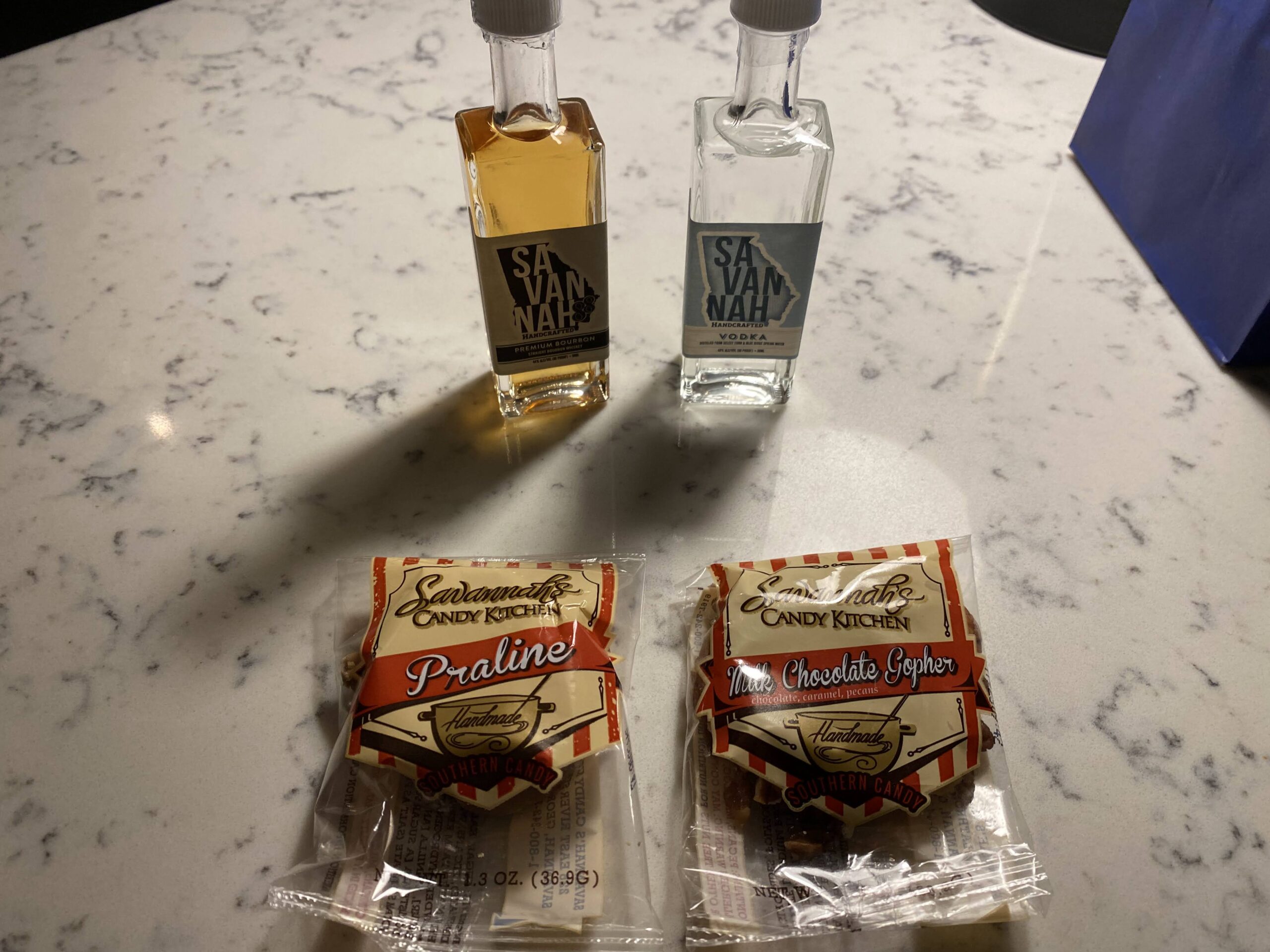 two small bottles of liquid and a couple packages of candy