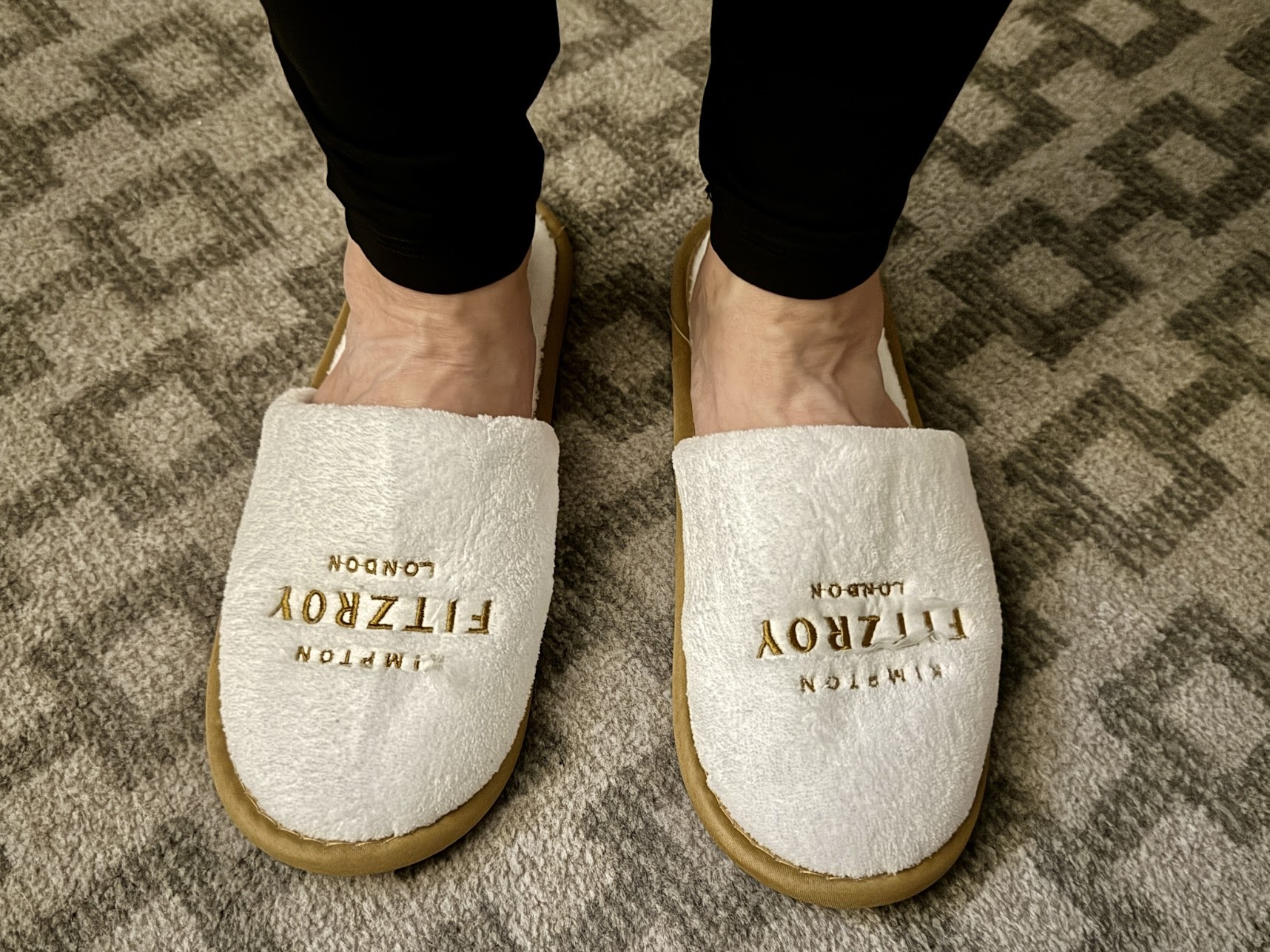 a person wearing slippers on a carpet