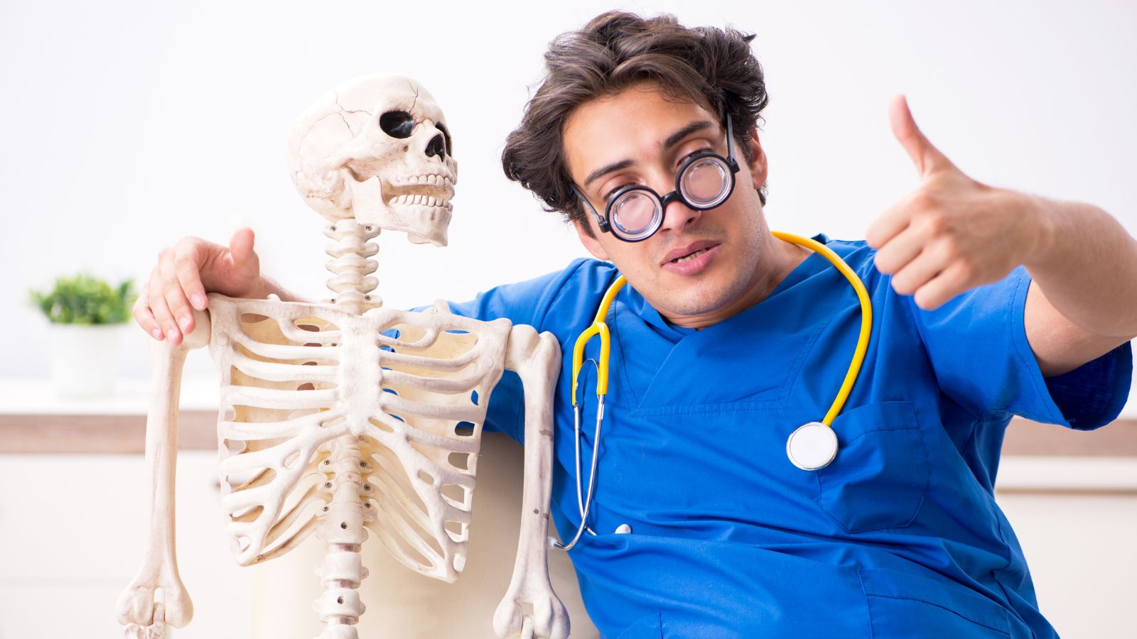 a doctor with a stethoscope around his neck and a skeleton
