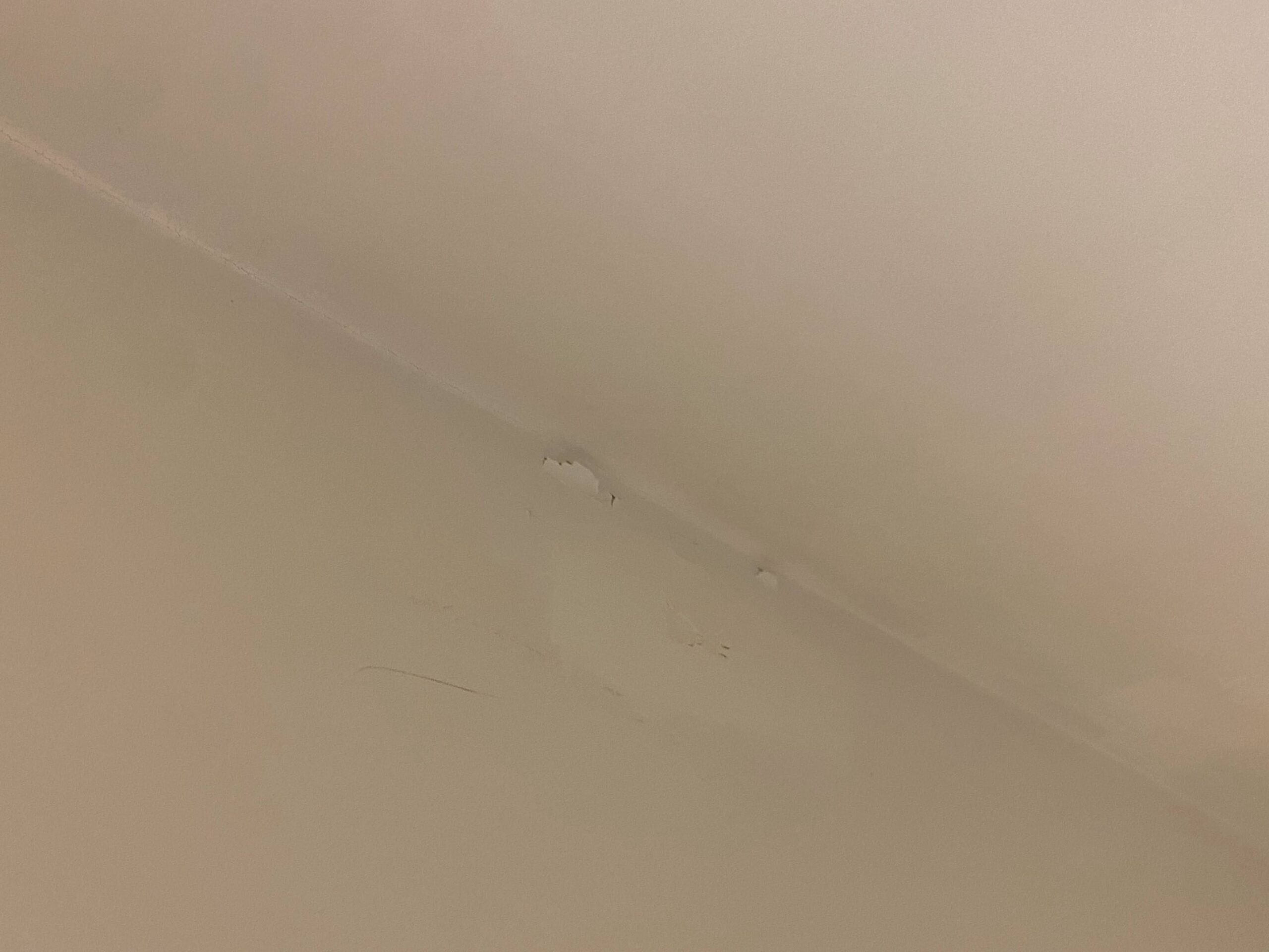 a white wall with a crack in the wall
