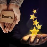 a person holding a cardboard box with stars coming out of their palm