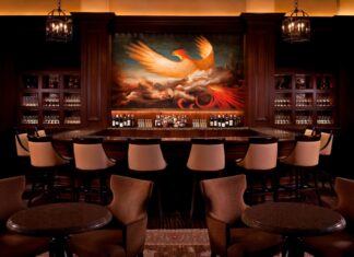 a bar with a painting of a bird on the wall