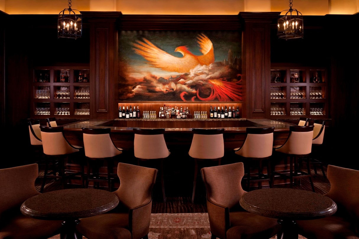 a bar with a painting of a bird on the wall