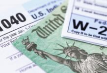 Fees for paying IRS taxes via PayPal trigger Venture Business software credit close-up of a tax form with a green bill and a statue of liberty on it