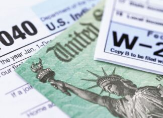 close-up of a tax form with a green bill and a statue of liberty on it