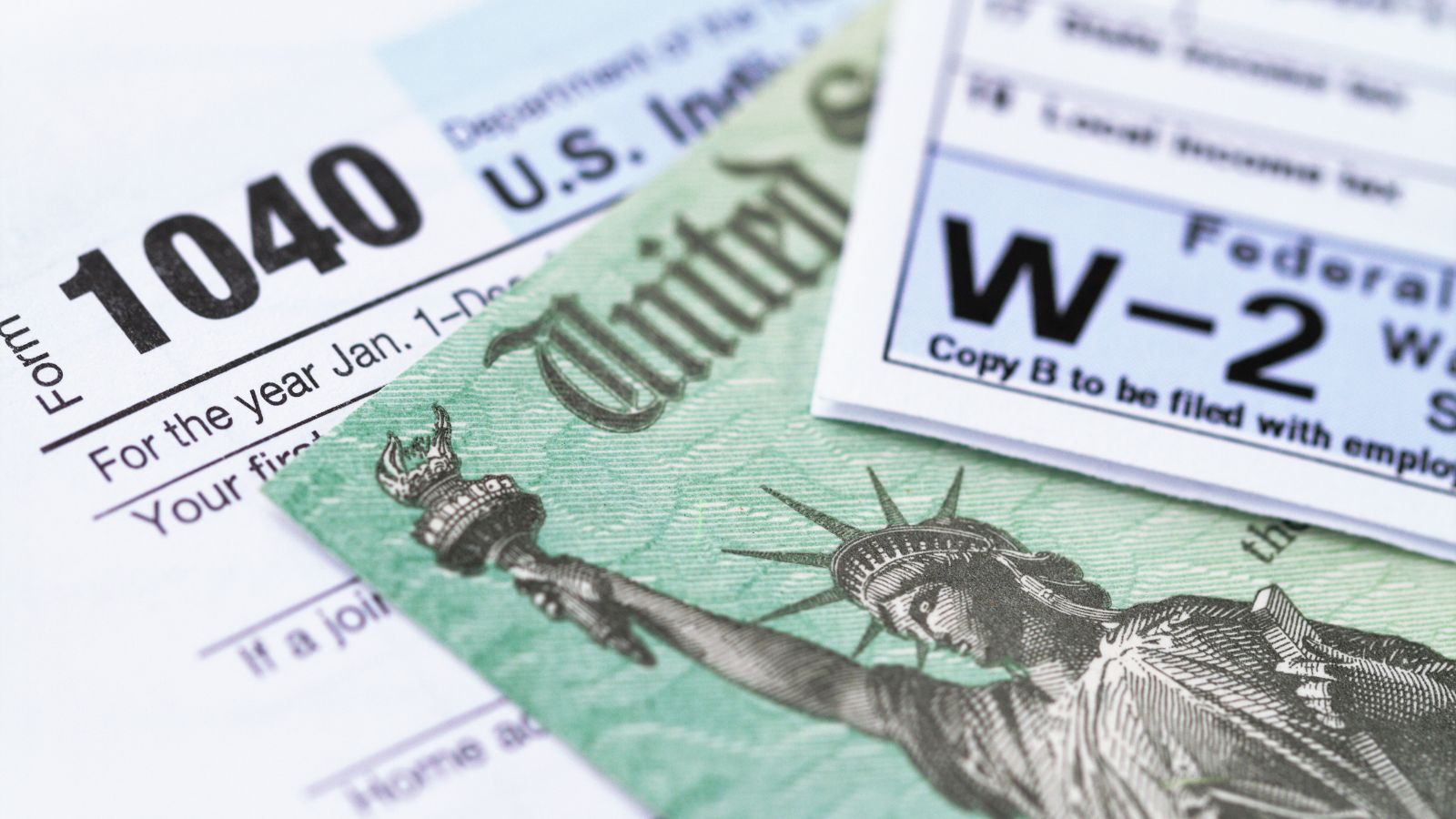close-up of a tax form with a green bill and a statue of liberty on it