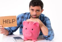 a man leaning on a piggy bank