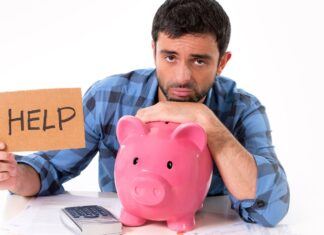 a man leaning on a piggy bank