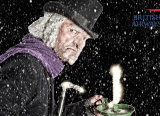 a man in a top hat holding a tea cup and smoking a candle