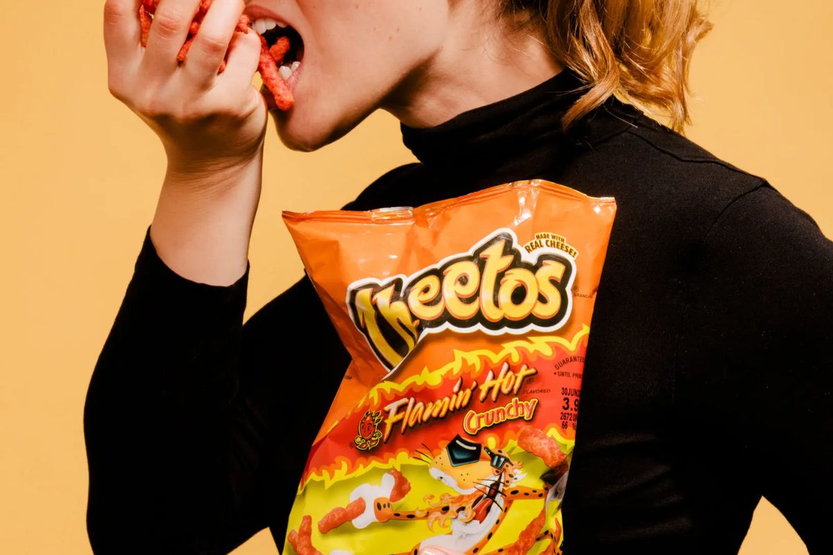 a woman eating a bag of chips