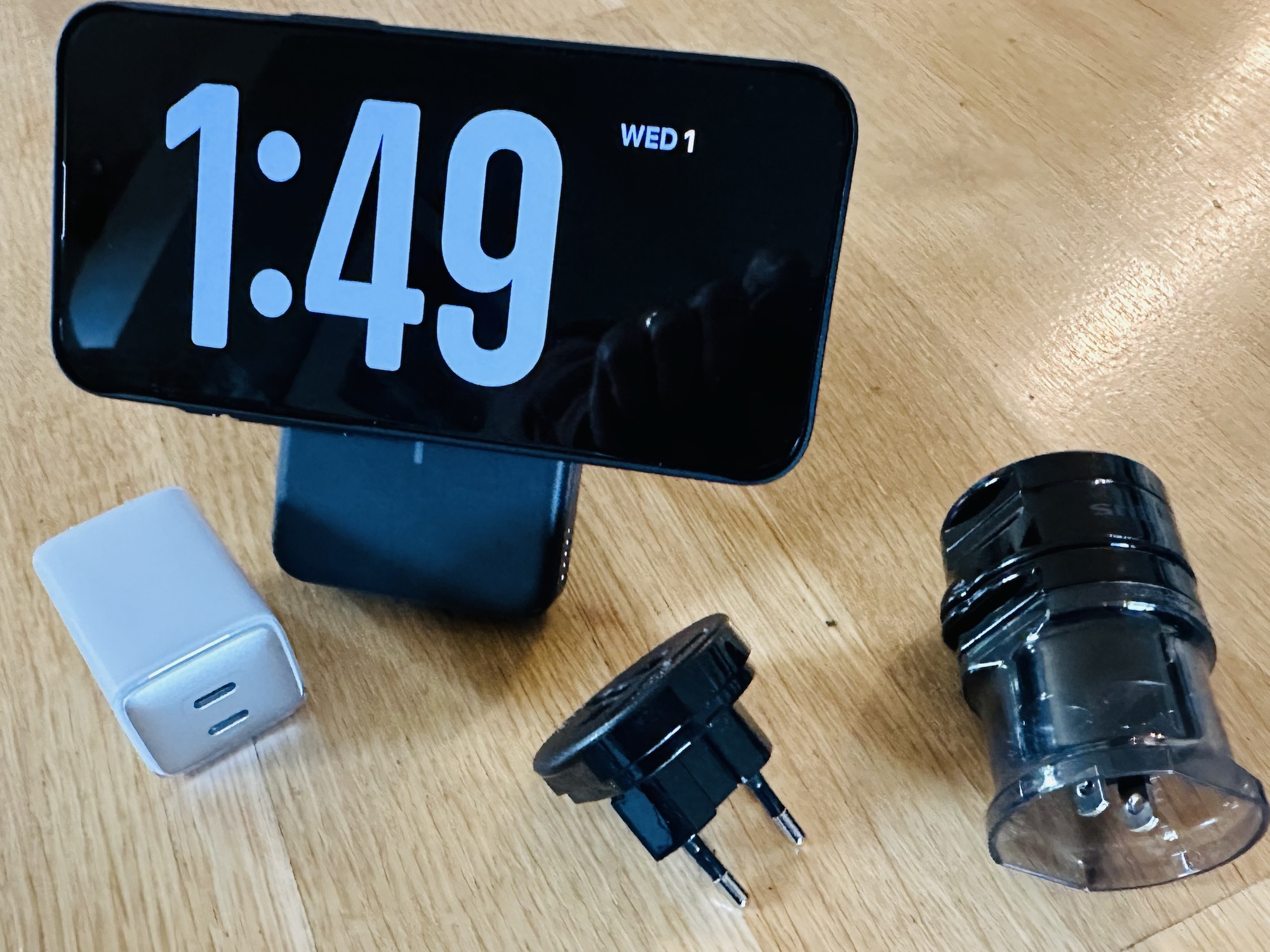 a digital clock and charger on a table