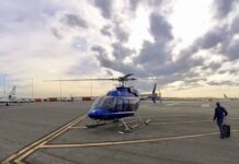 a blue helicopter on a tarmac