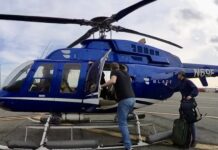 a group of people getting off a helicopter